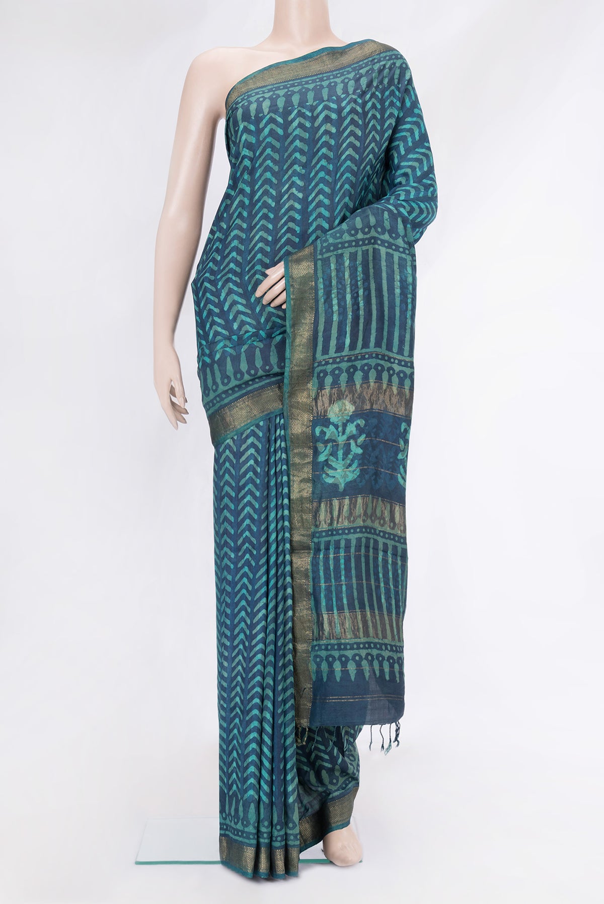 Peacock Blue Dual Tone Tussar Silk Saree with Printed design on the body and Zari Border.  displayed on a mannequin