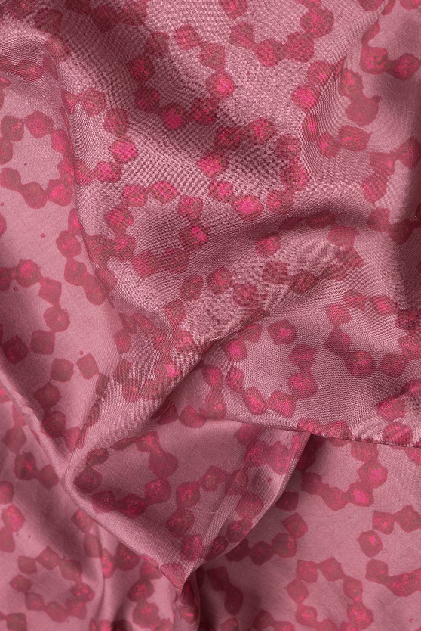Close up of Pink Dual Tone Printed Silk Saree with Printed design on the body and Zari Border.  displaying folds