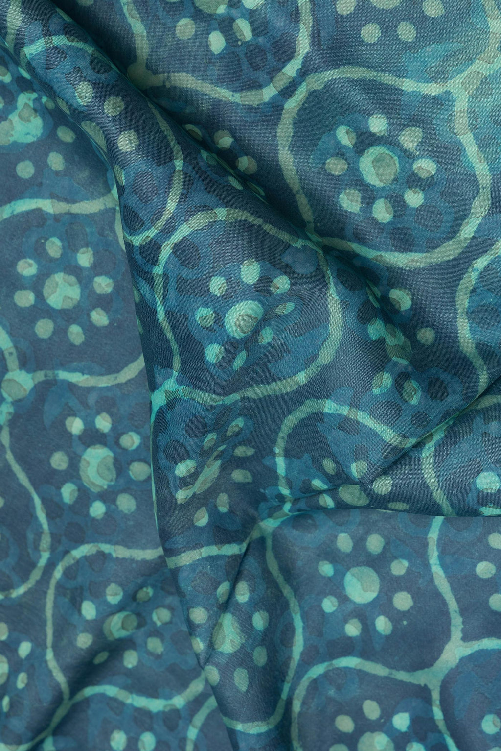 Close up of Pure Silk Blue Dual Tone Tussar Saree with Printed design on the body and Zari Border.  displaying folds