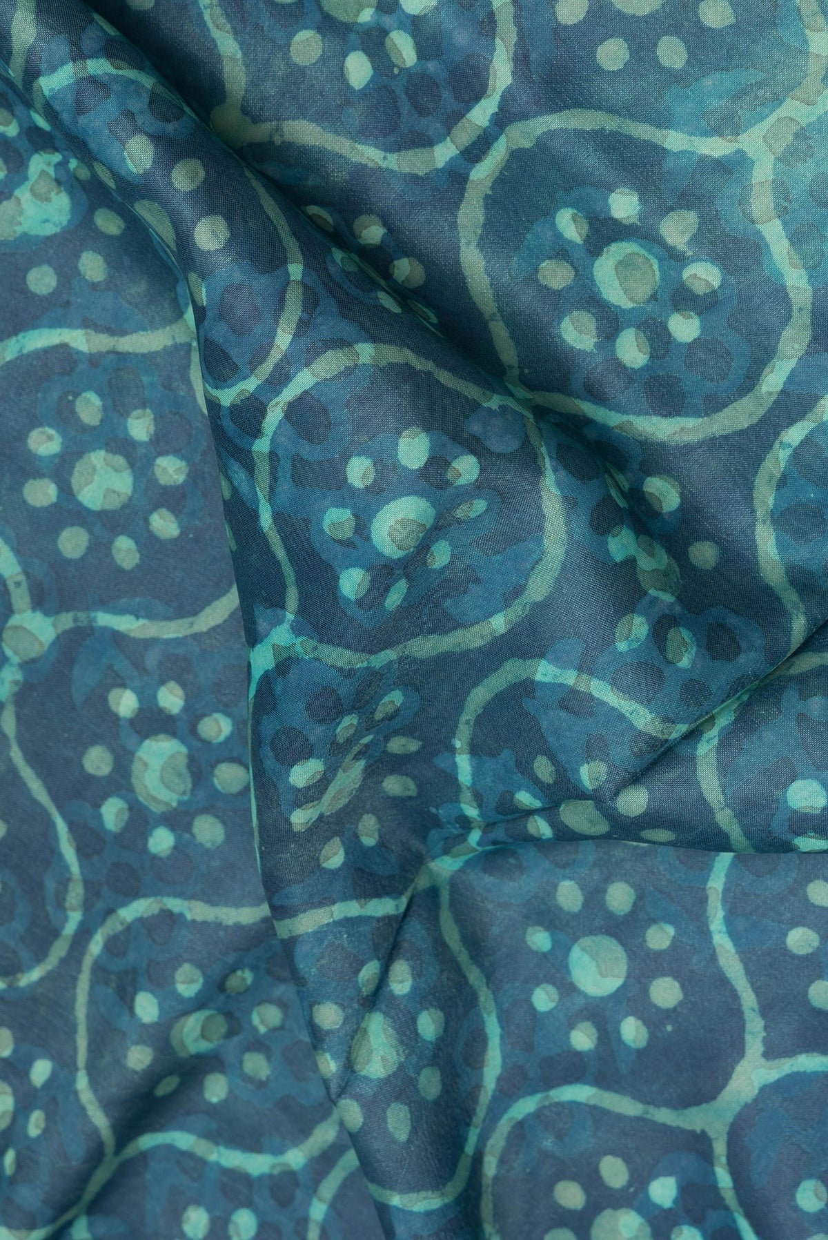 Close up of Pure Silk Blue Dual Tone Tussar Saree with Printed design on the body and Zari Border.  displaying folds