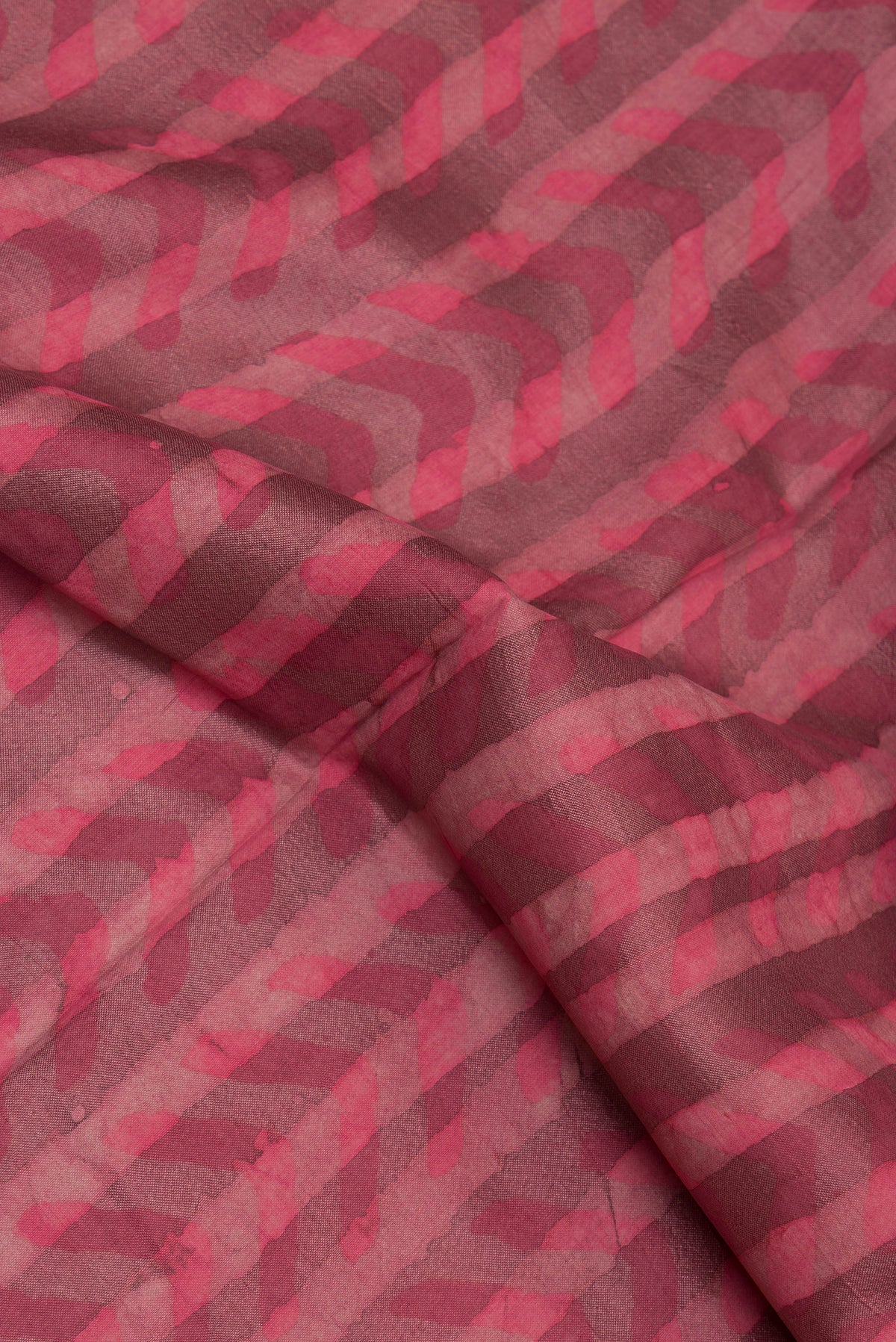 Close up of Pure Silk Pink Dual Tone Tussar Saree with Printed design on the body and Zari Border.  displaying folds