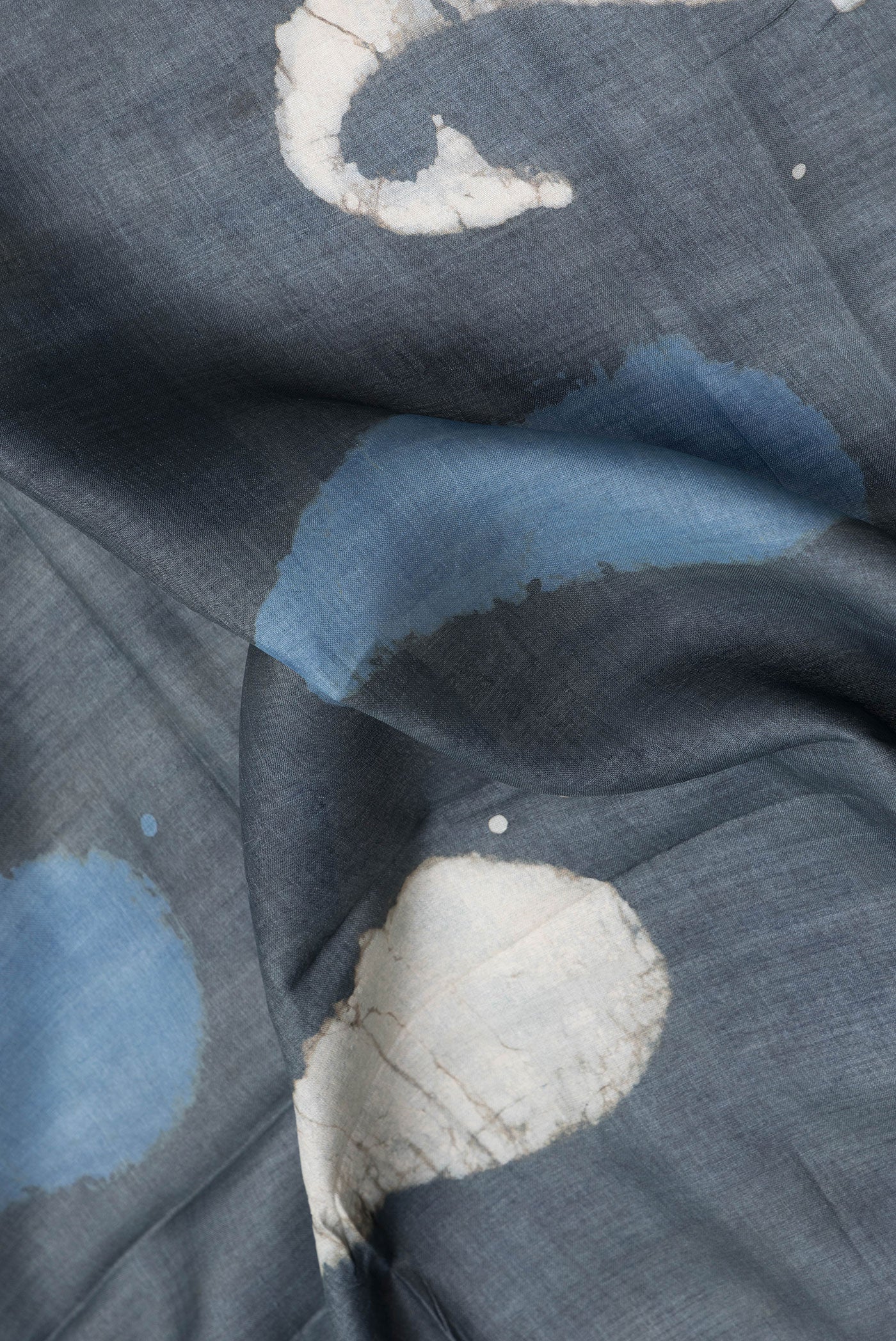 Close up of Grey Tussar Silk Saree with Printed design on the body and Printed Border.  displaying folds