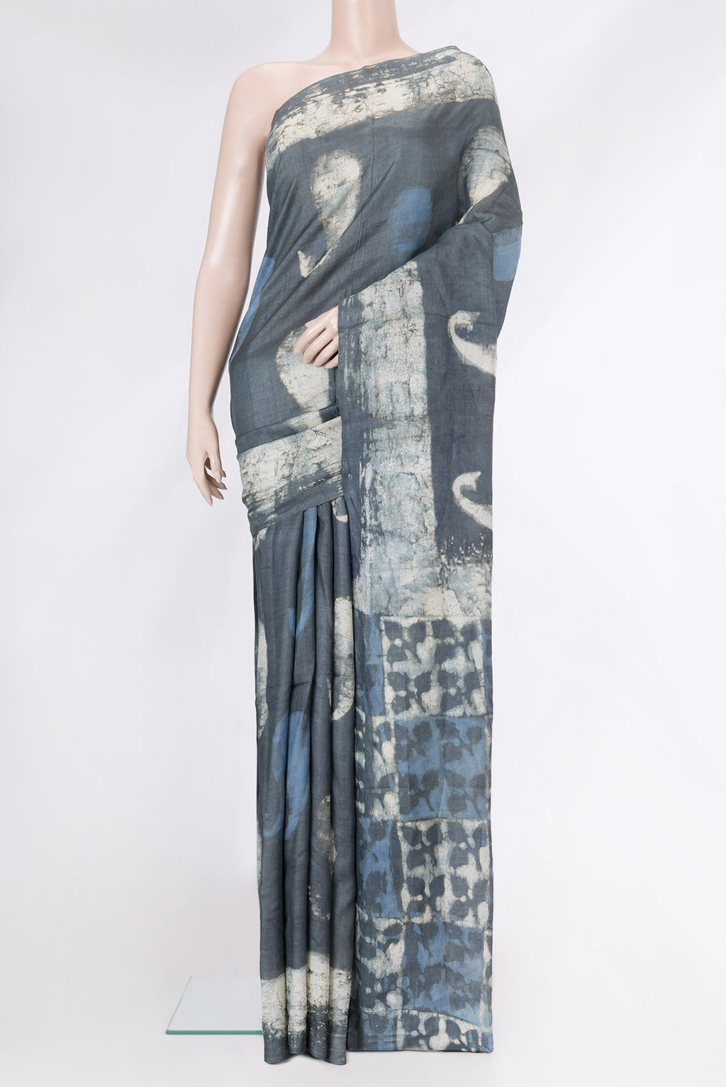 Grey Tussar Silk Saree with Printed design on the body and Printed Border.  displayed on a mannequin