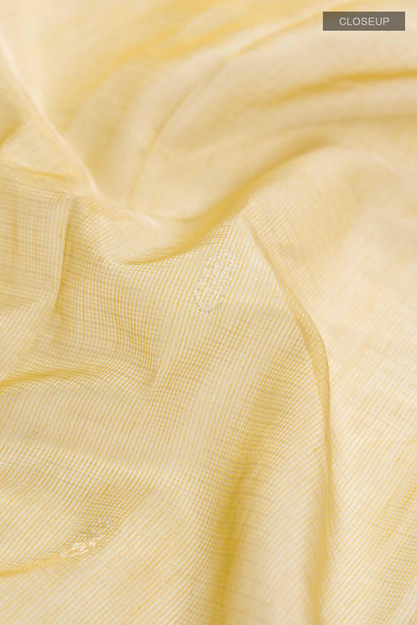 Close up of Yellow Maheshwari Silk Cotton Saree with Zari Butta on the body and Zari Border displaying folds