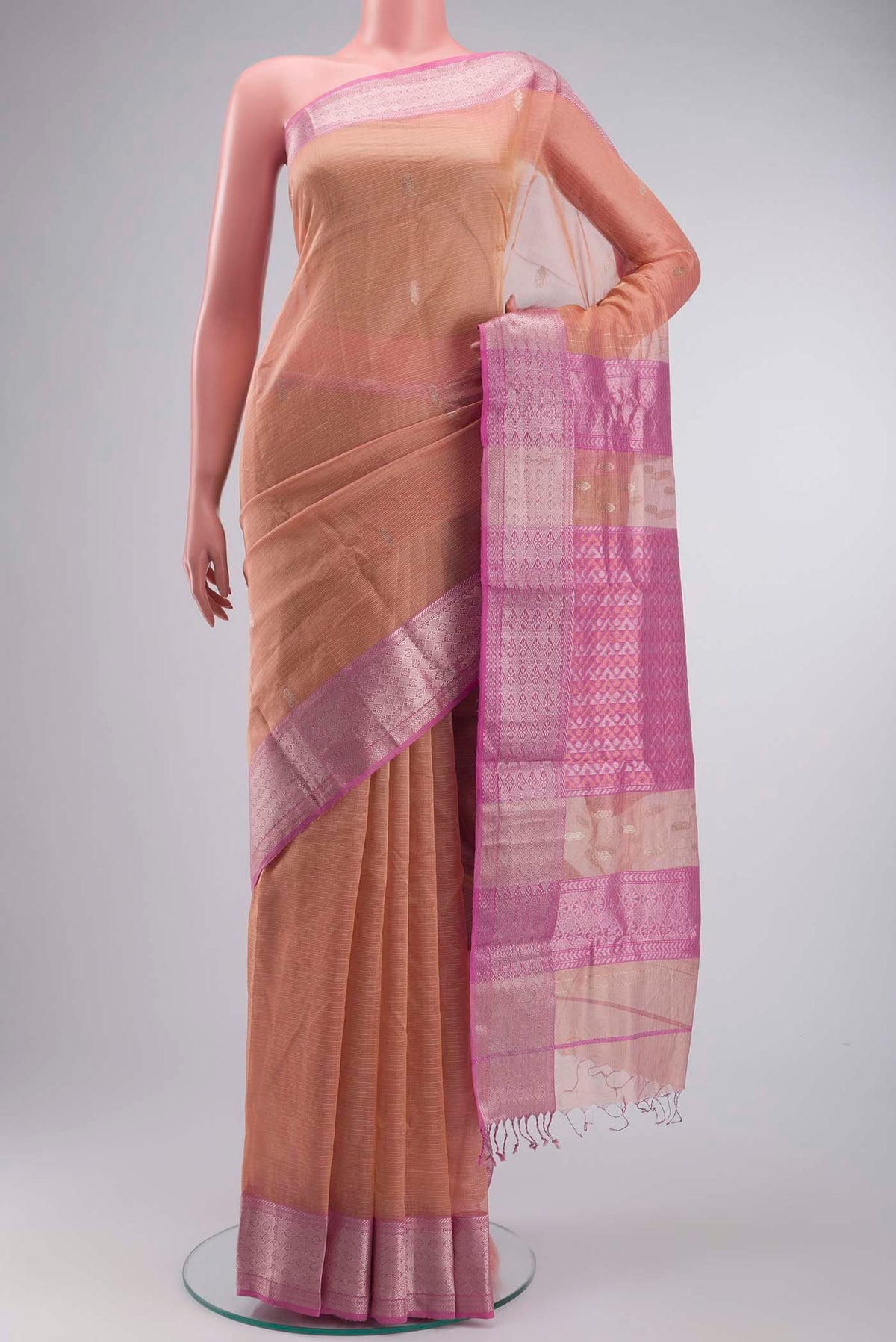 Peach Maheshwari Silk Cotton Saree with Zari Butta on the body and Zari Border displayed on a mannequin