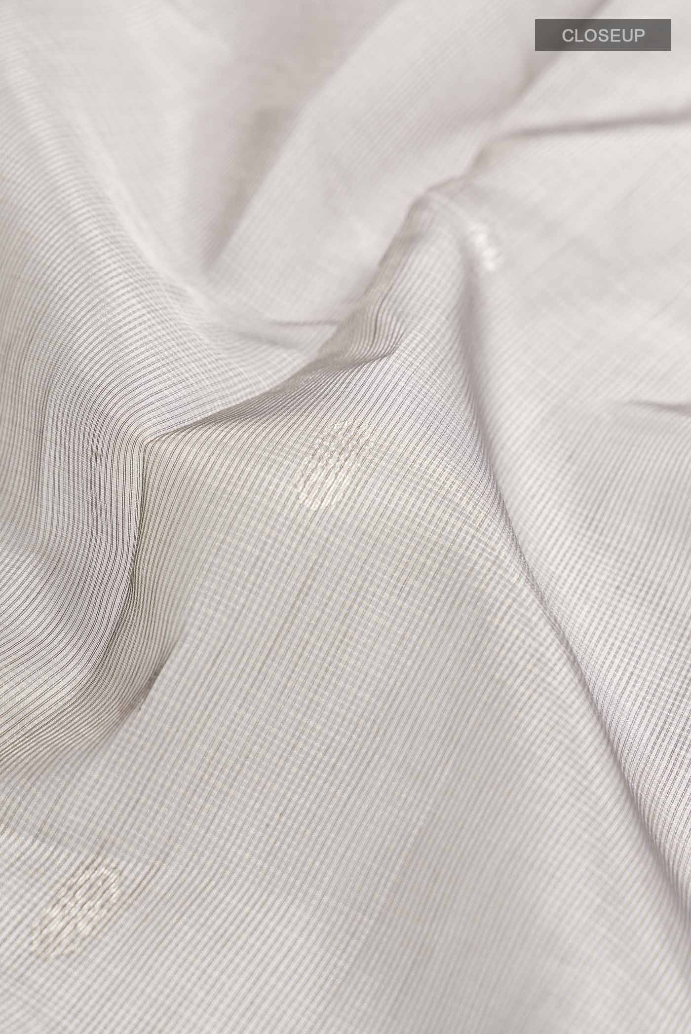 Close up of Grey Maheshwari Silk Cotton Saree with Zari Butta on the body and Zari Border displaying folds