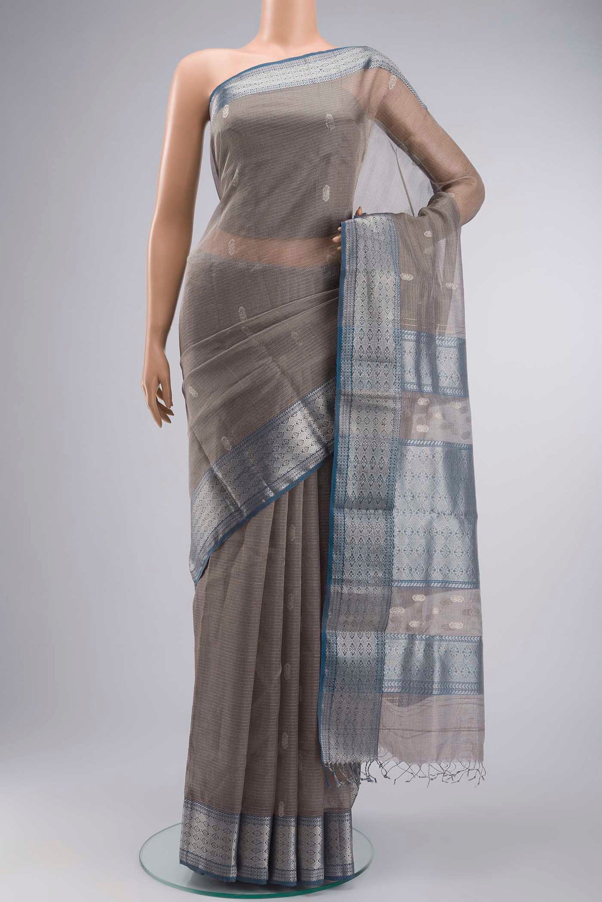 Grey Maheshwari Silk Cotton Saree with Zari Butta on the body and Zari Border displayed on a mannequin