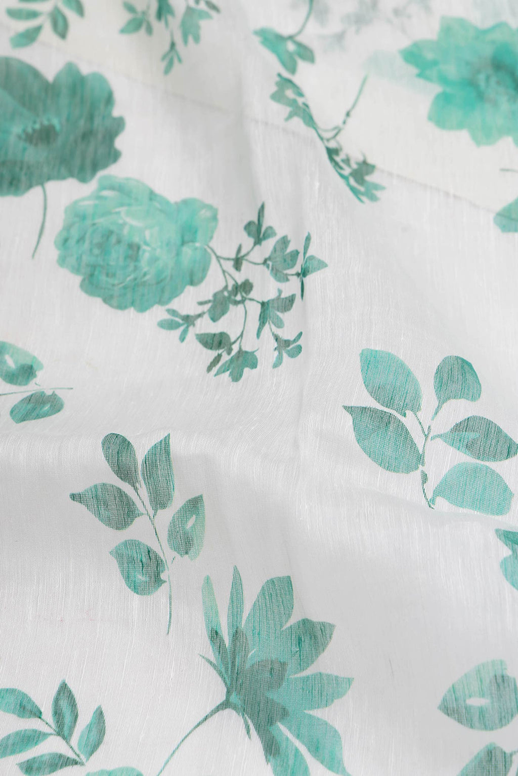 Close up of Off White Dual Tone Linen Saree with Printed design on the body and Plain Border.  displaying folds