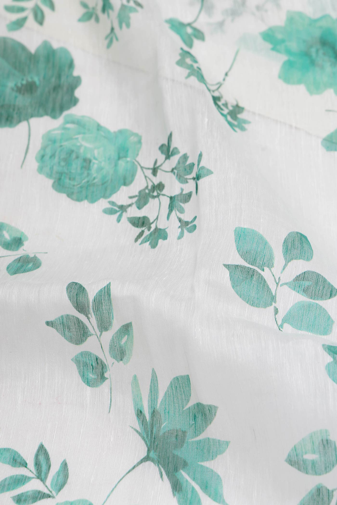 Close up of Off White Dual Tone Linen Saree with Printed design on the body and Plain Border.  displaying folds