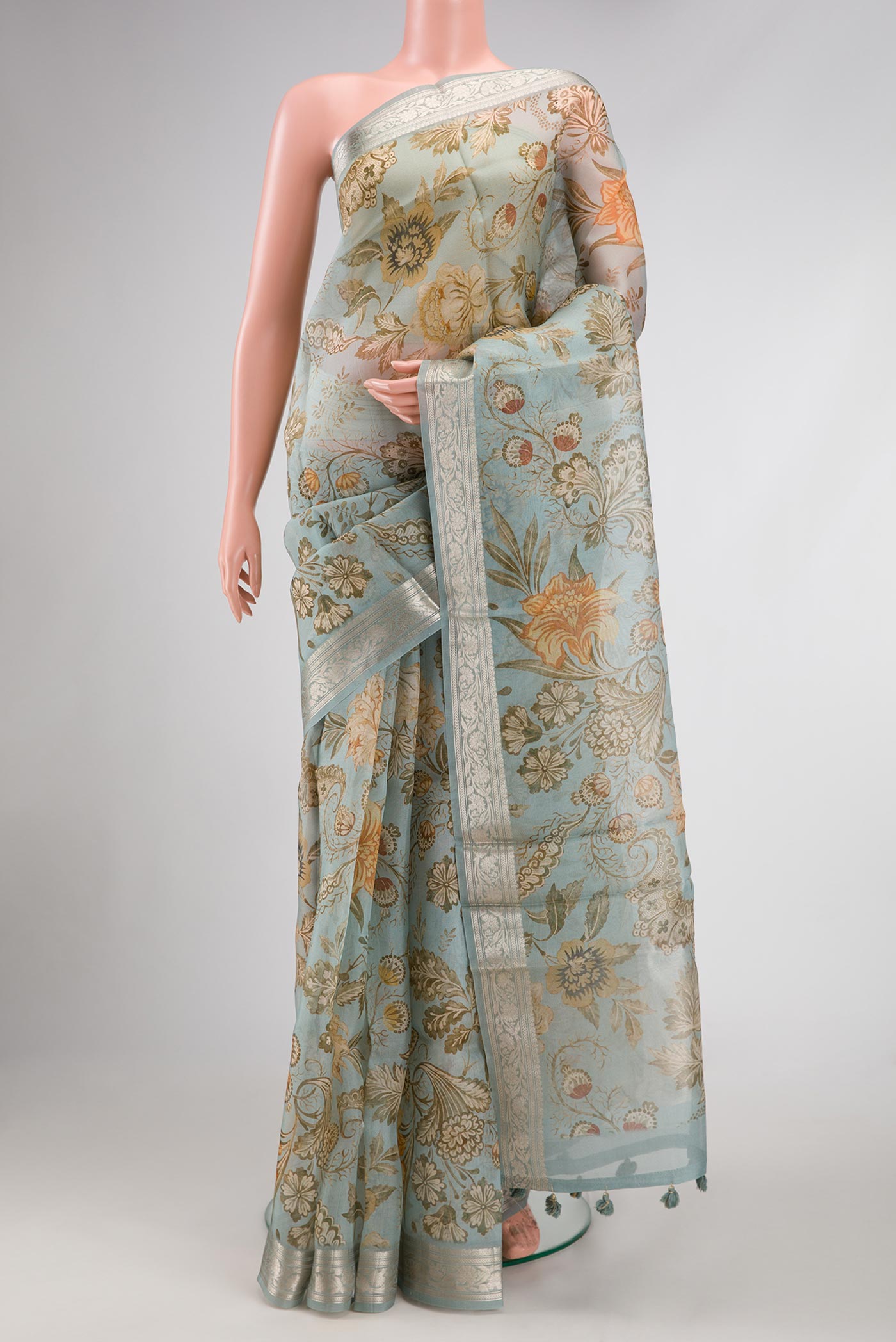 Light Blue Dual Tone Organza Silk Saree with Printed design on the body and Zari Border.  displayed on a mannequin