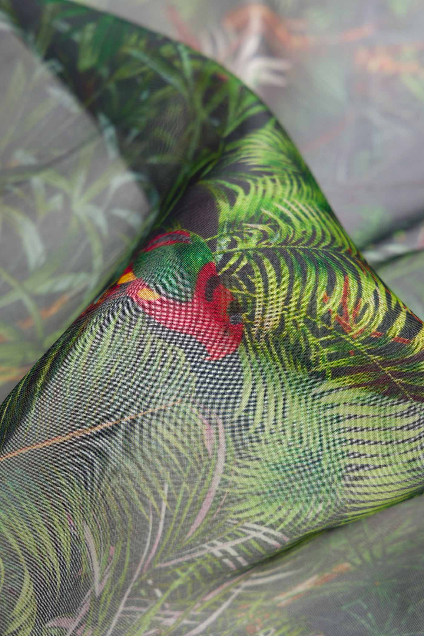 Close up of Bottle Green Dual Tone Organza Silk Saree with Printed design on the body and Zari Border.  displaying folds
