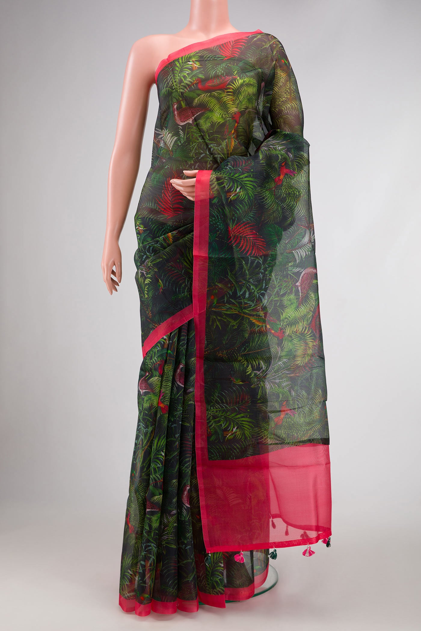 Bottle Green Dual Tone Organza Silk Saree with Printed design on the body and Zari Border.  displayed on a mannequin
