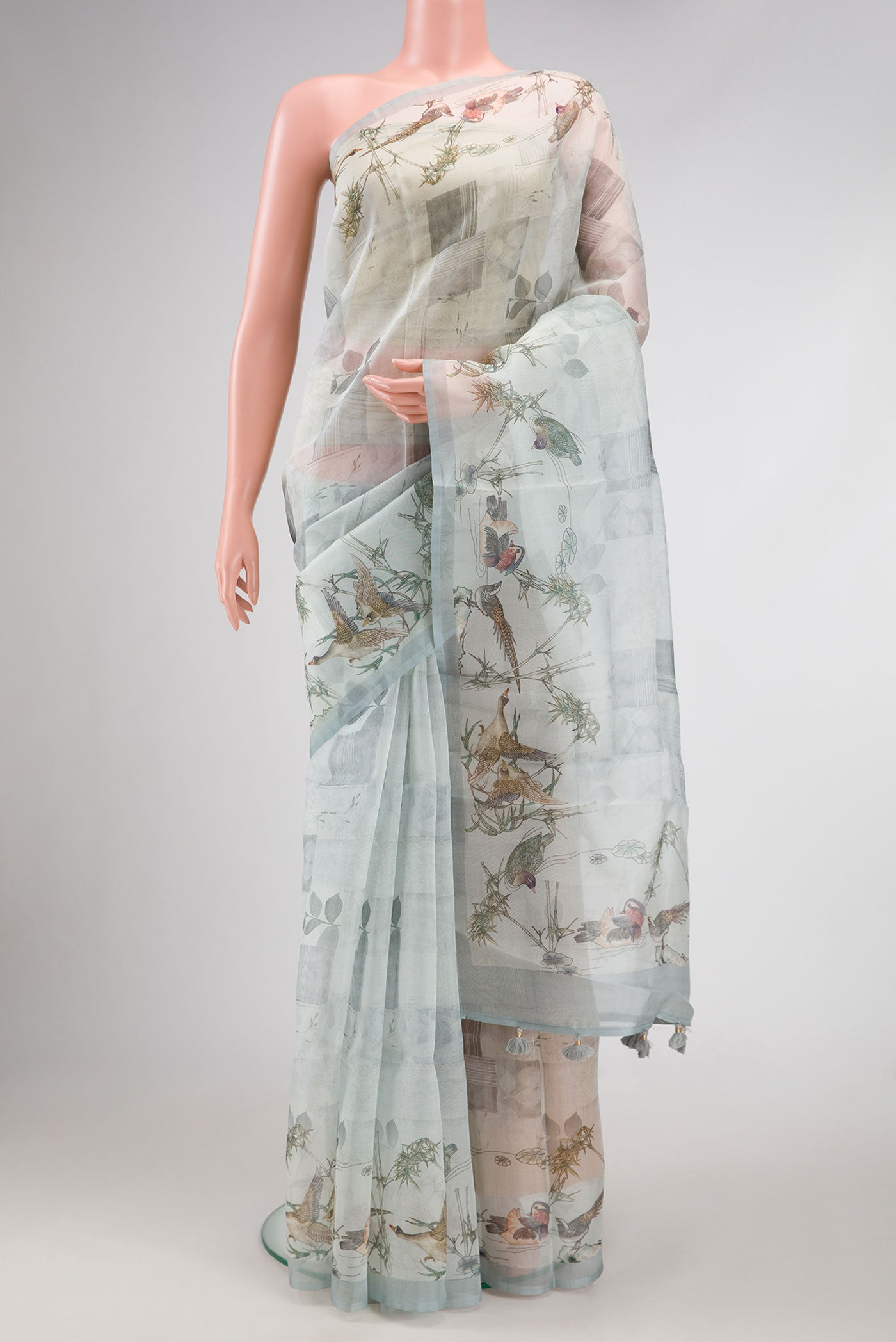 Grey Dual Tone Organza Silk Saree with Printed design on the body and Zari Border.  displayed on a mannequin