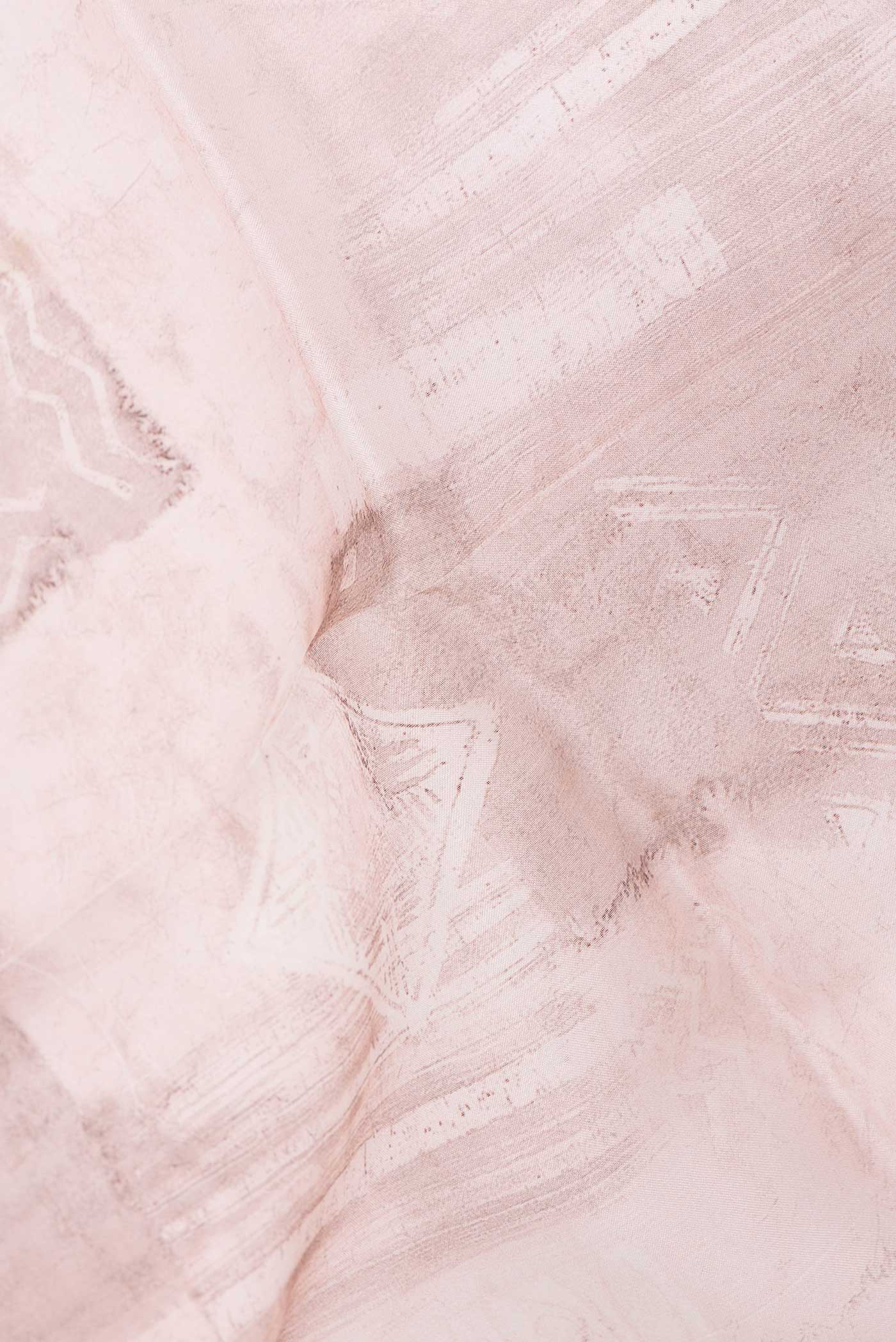 Close up of Golden Peach Dual Tone Organza Silk Saree with Printed design on the body and Printed Border displaying folds