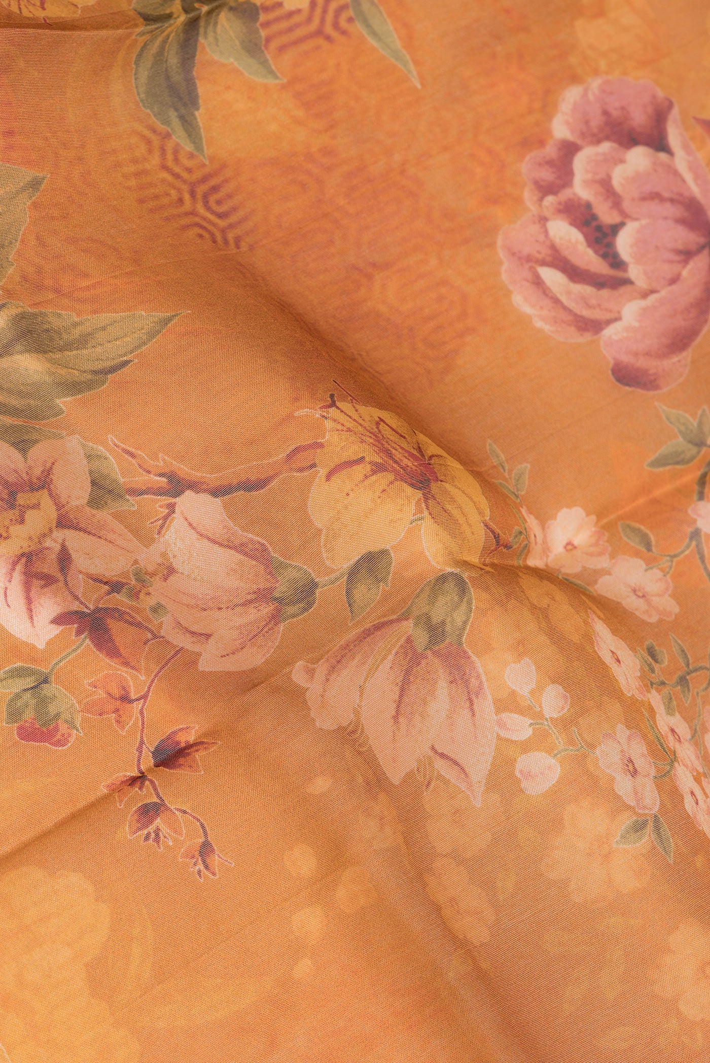 Close up of Orange Dual Tone Organza Silk Saree with Printed design on the body and Without Border.  displaying folds