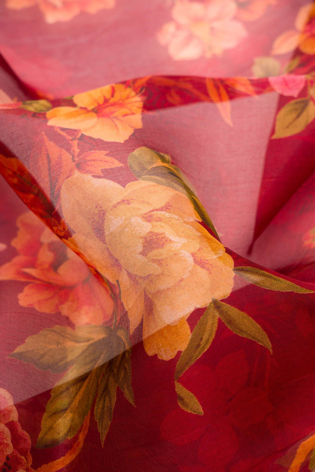 Close up of Maroon Dual Tone Organza Silk Saree with Printed design on the body and Without Border.  displaying folds