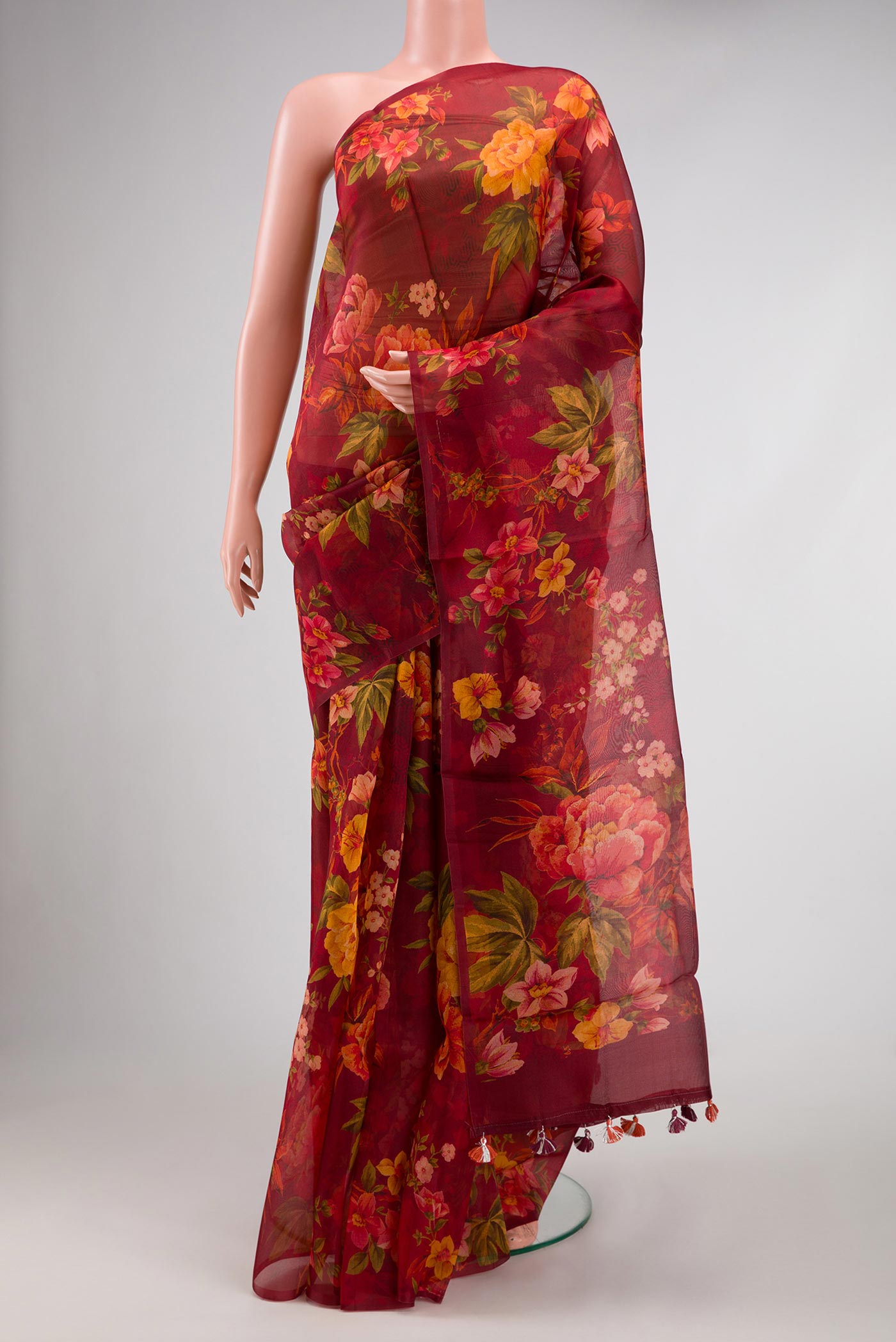 Maroon Dual Tone Organza Silk Saree with Printed design on the body and Without Border.  displayed on a mannequin