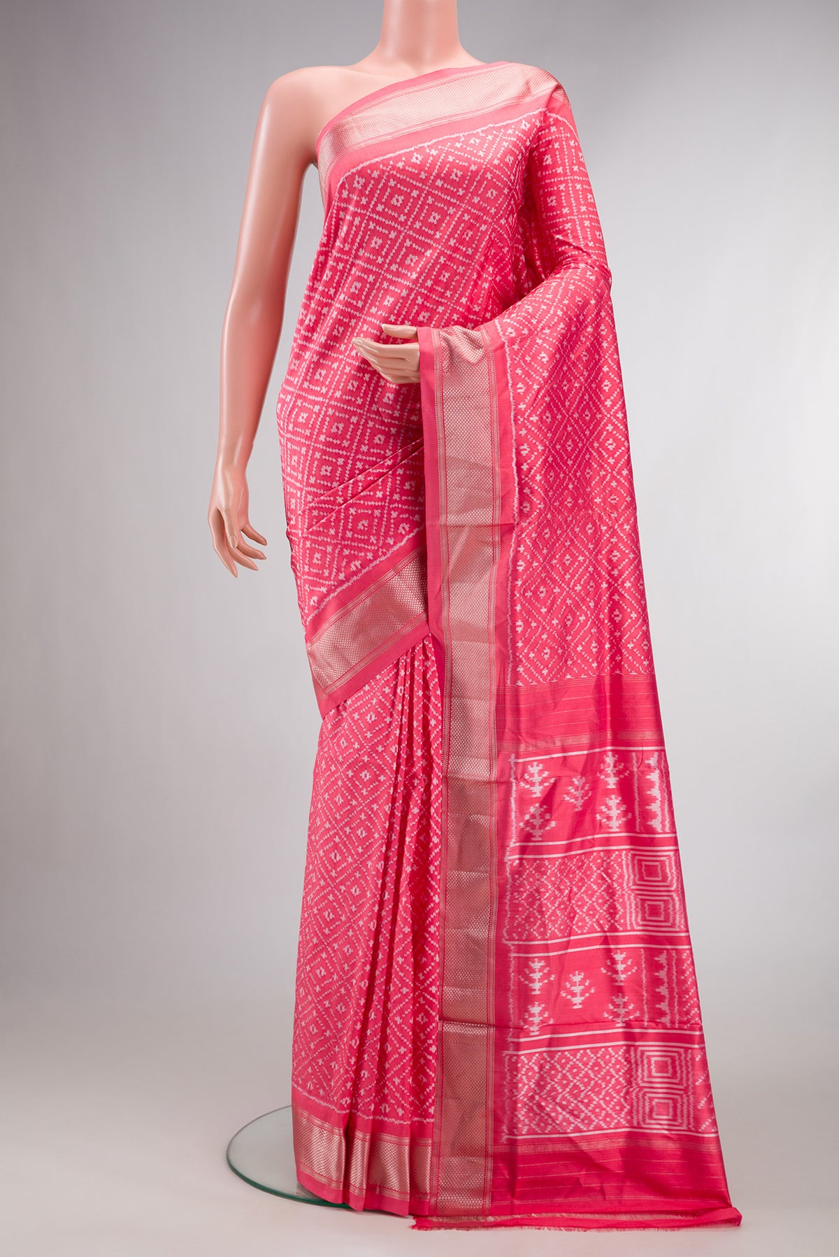 Pure Silk Coral Dual Tone Pochampally Saree with Ikat design on the body and Zari Border.  displayed on a mannequin