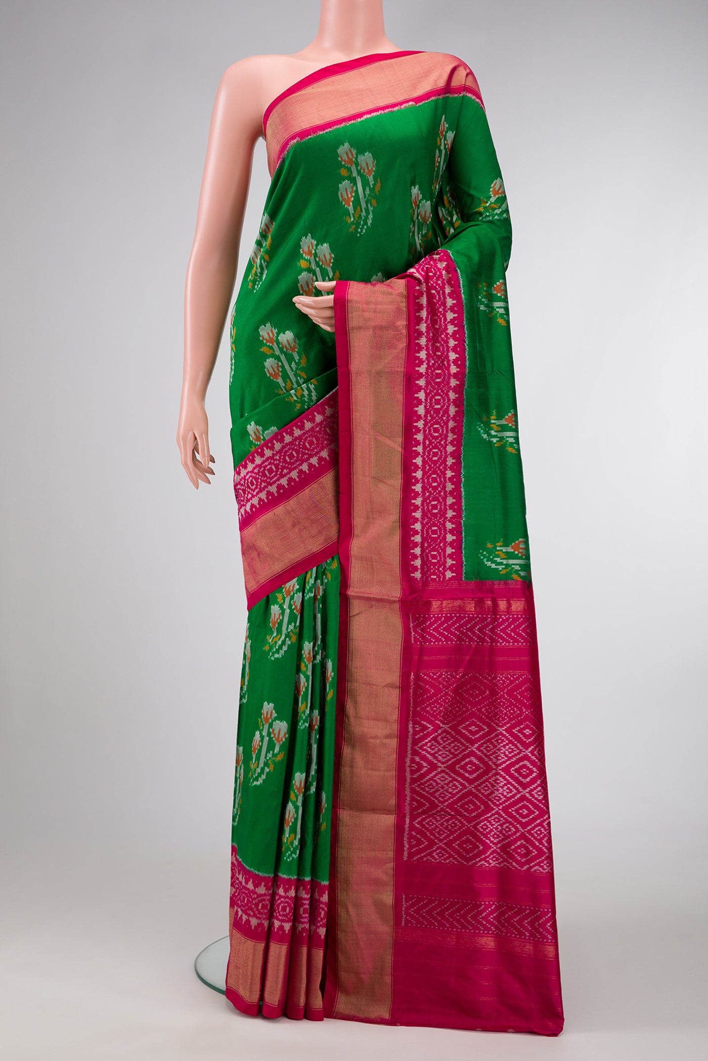 Green Dual Tone Double Ikat Saree with Ikat Print on the body and Ikat Border.  displayed on a mannequin
