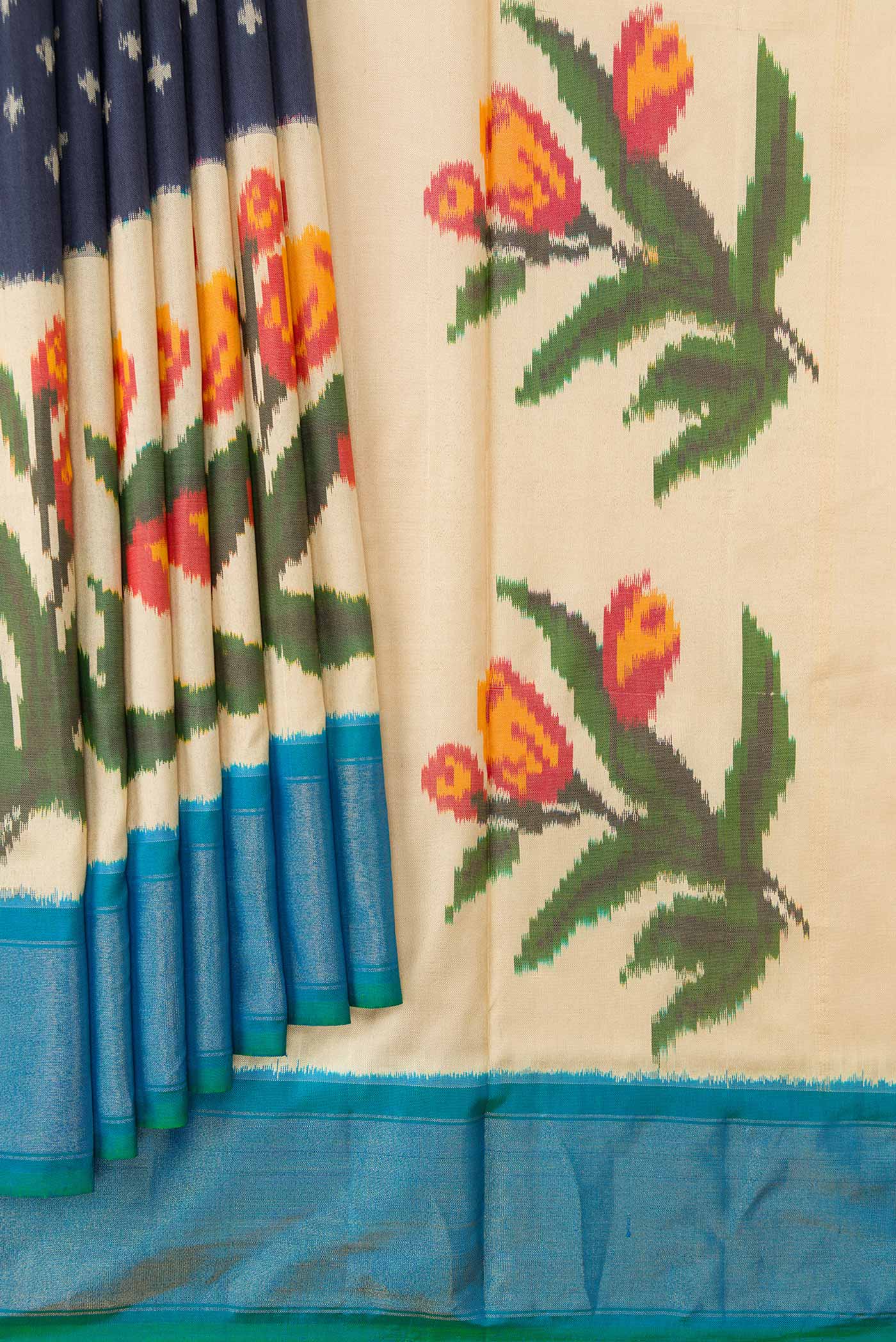 Pleats and pallu of Navy Blue Dual Tone Double Ikat Saree with Ikat Print on the body and Zari Border. 