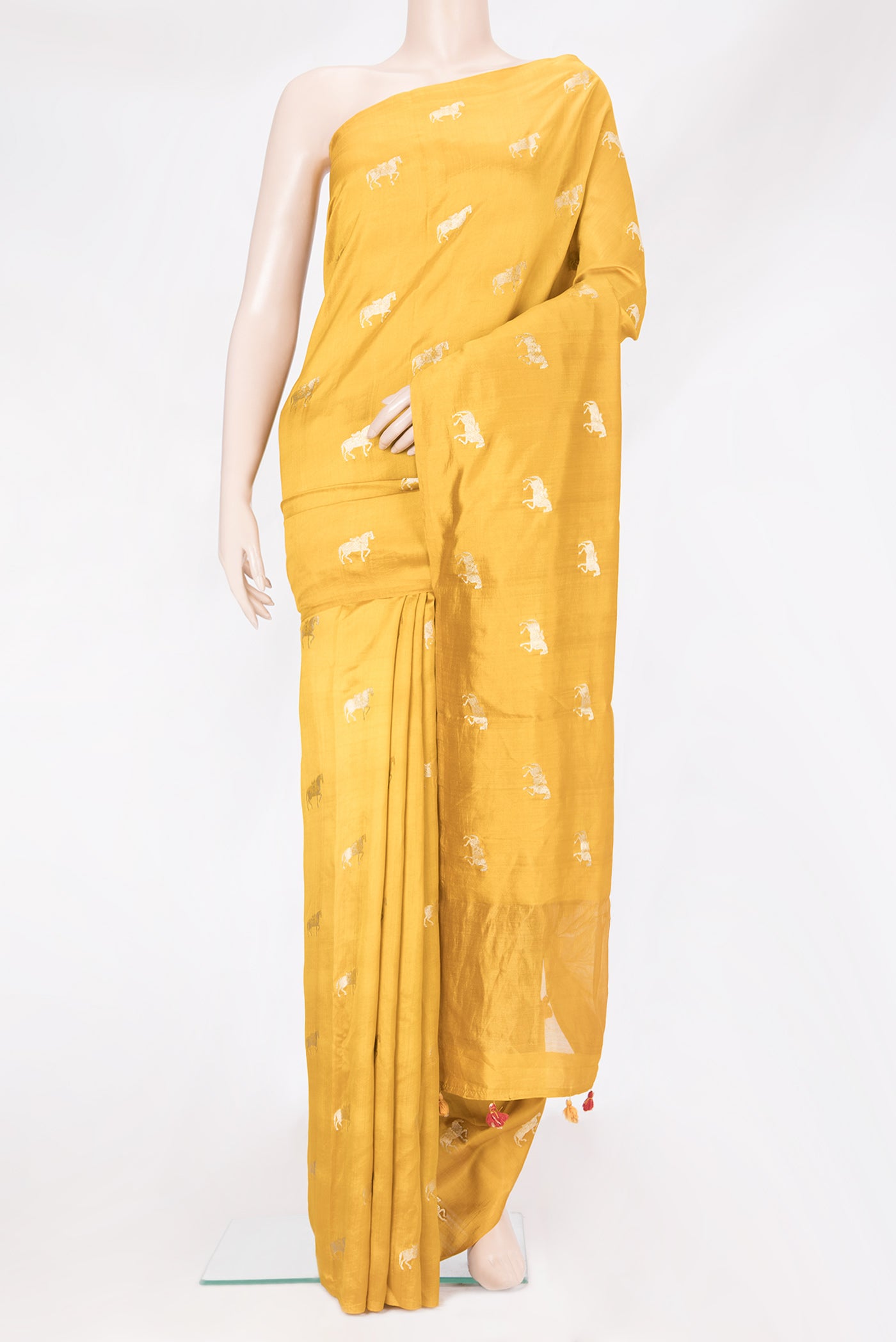 Mustard Tussar Silk Saree with Zari Butta on the body and Without Border.  displayed on a mannequin