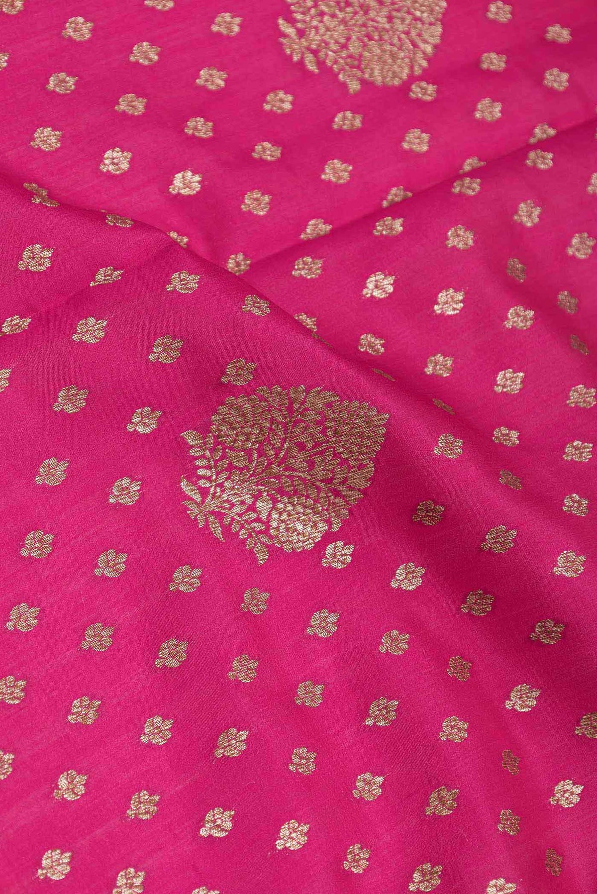 Close up of Rani Pink Dual Tone Tussar Silk Saree with Zari Butta on the body and Zari Border displaying folds