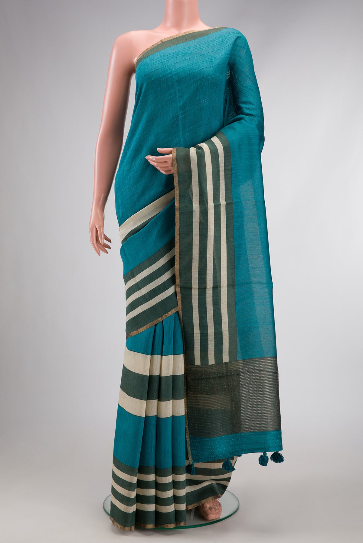 Peacock Blue Dual Tone Tussar Silk Saree with Embroidery on the body and Embroidery Border.  displayed on a mannequin