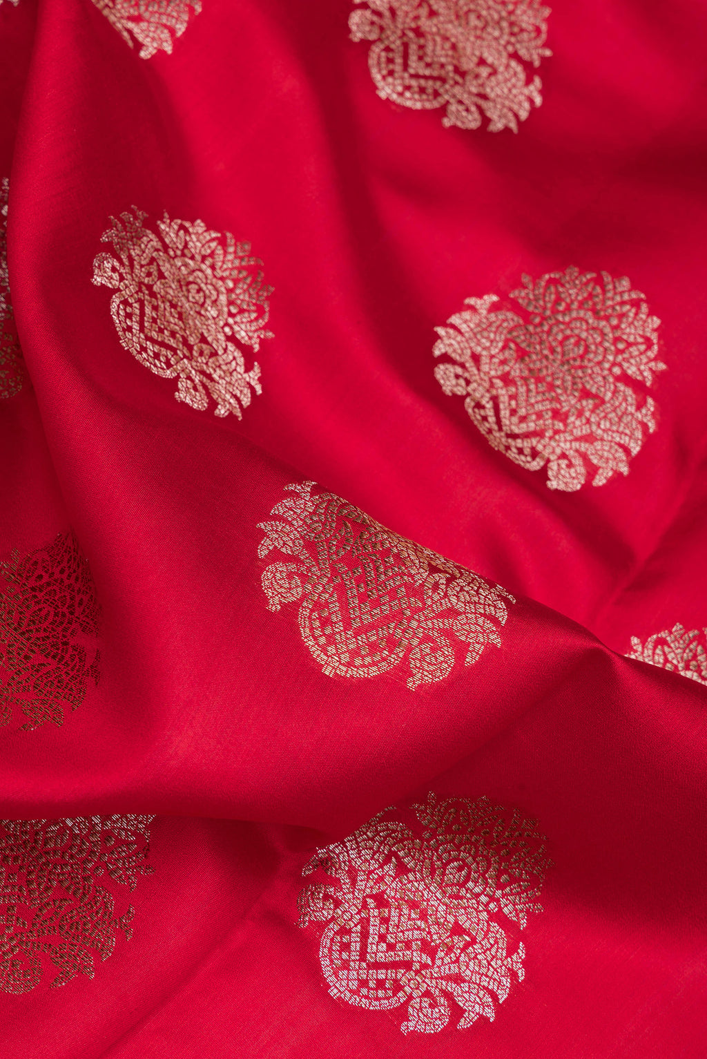 Close up of Maroon Dual Tone Tussar Silk Saree with Zari Butta on the body and Zari Border.  displaying folds