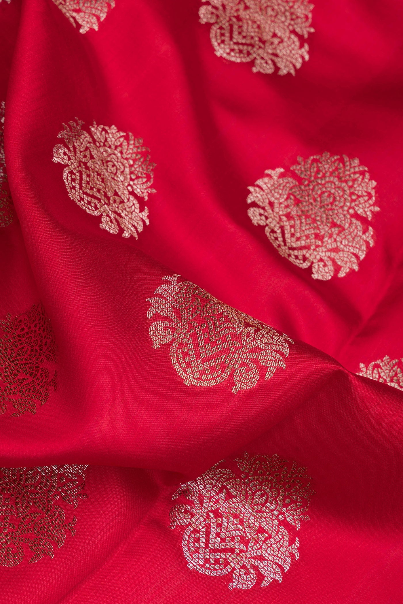 Close up of Maroon Dual Tone Tussar Silk Saree with Zari Butta on the body and Zari Border.  displaying folds