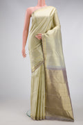Cream Kanjivaram Silk Saree with Zari Brocade on the body and Zari Border.  displayed on a mannequin