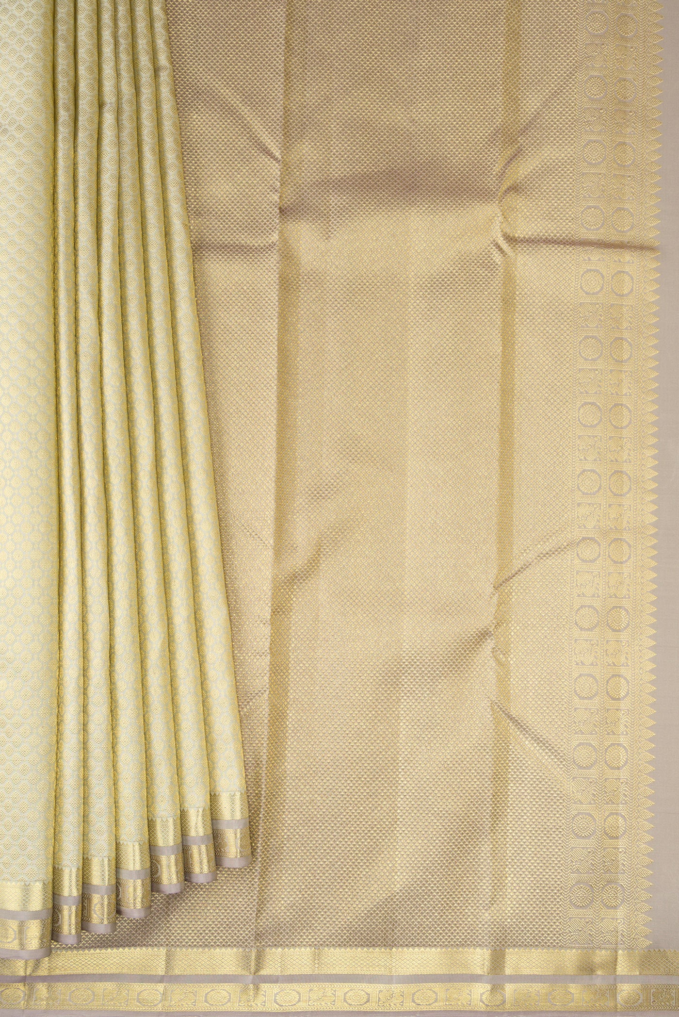 Pleats and pallu of Cream Kanjivaram Silk Saree with Zari Brocade on the body and Zari Border. 