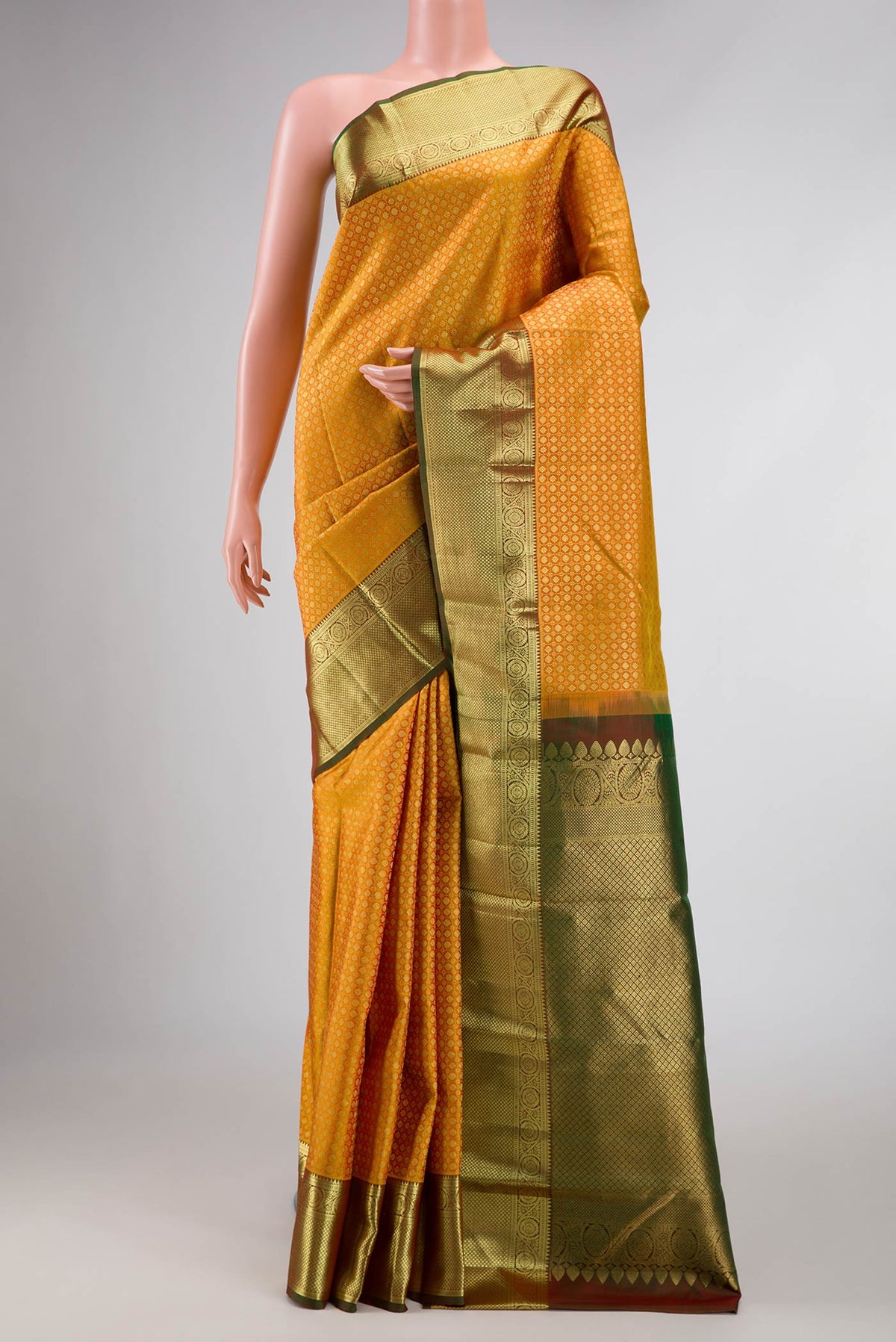 Mustard Dual Tone Kanchipuram Silk Saree with Zari Brocade on the body and Zari Border displayed on a mannequin