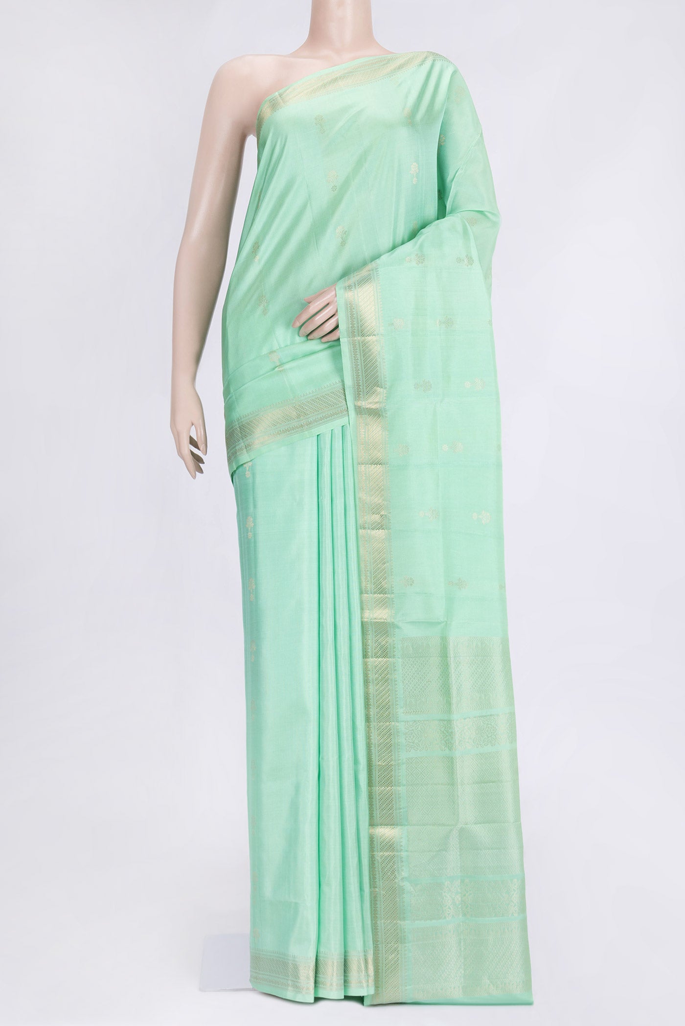 Pista Green Dual Tone Soft Silk Saree with Zari Butta on the body and Zari Border.  displayed on a mannequin