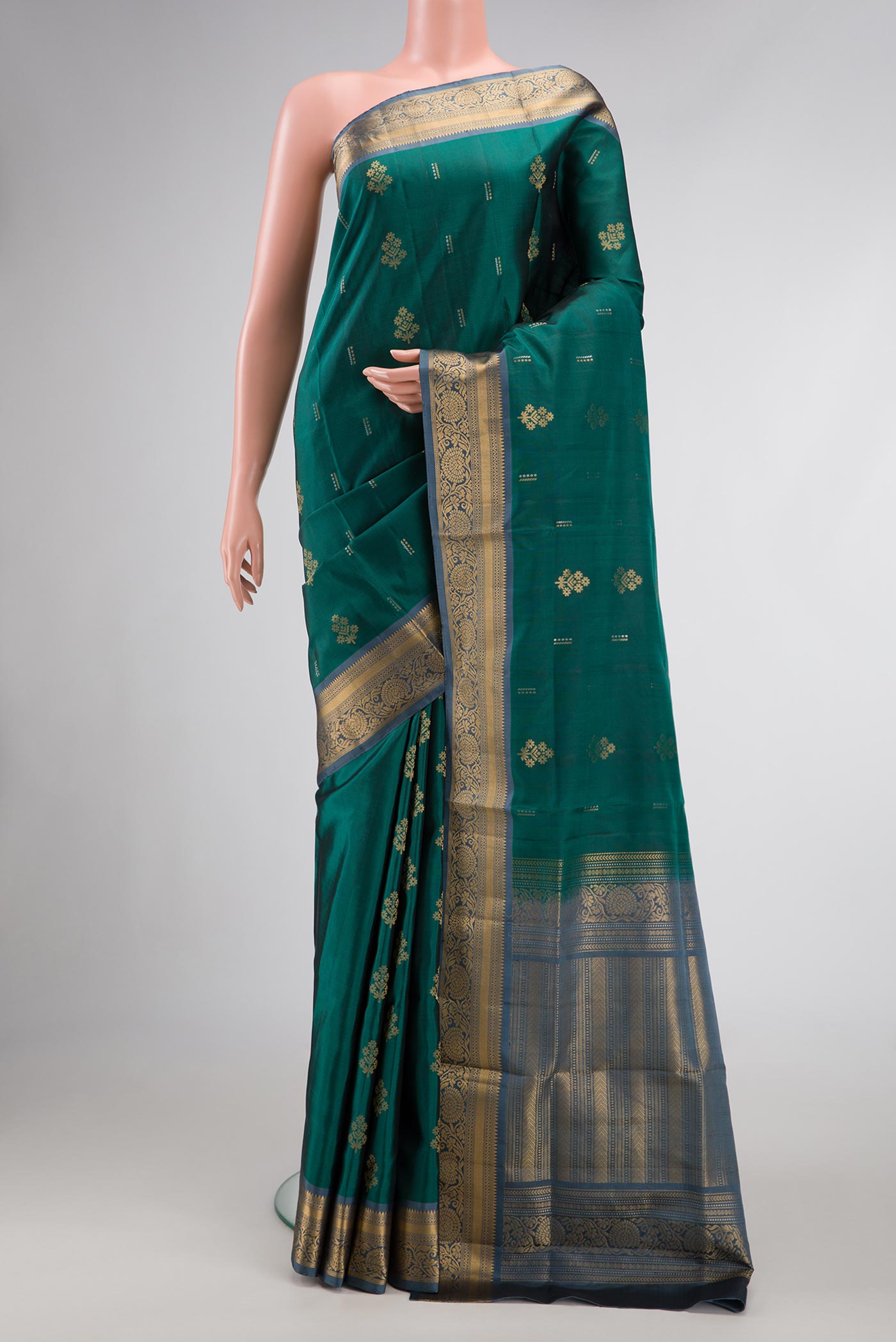 Green Dual Tone Soft Silk Saree with Zari Butta on the body and Zari Border.  displayed on a mannequin