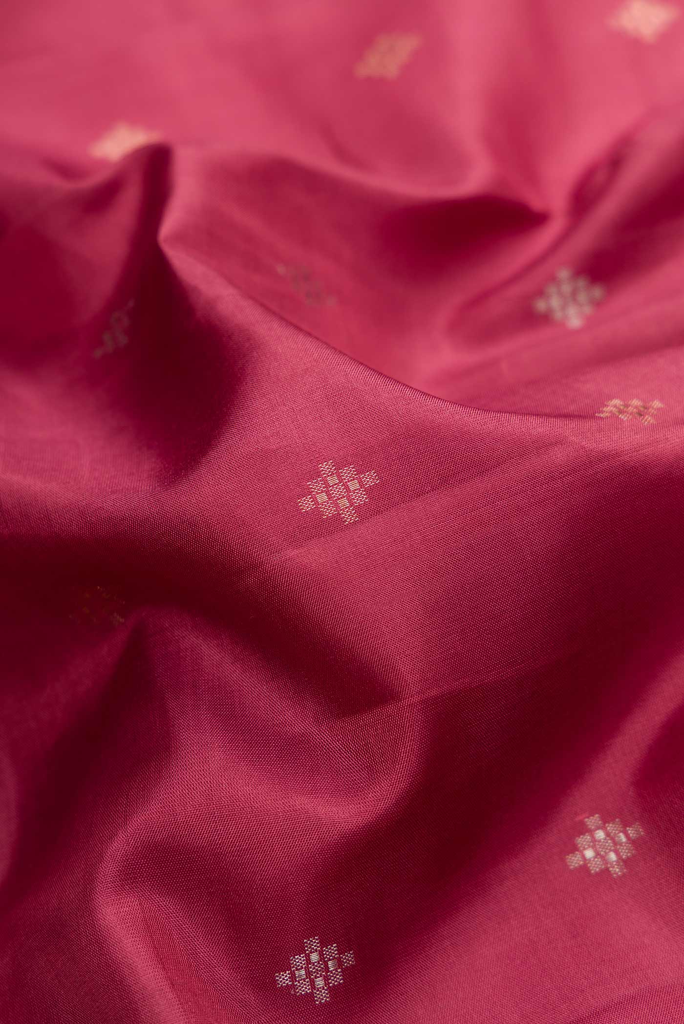Close up of Maroon Dual Tone Soft Silk Saree with Zari Butta on the body and Zari Border.  displaying folds