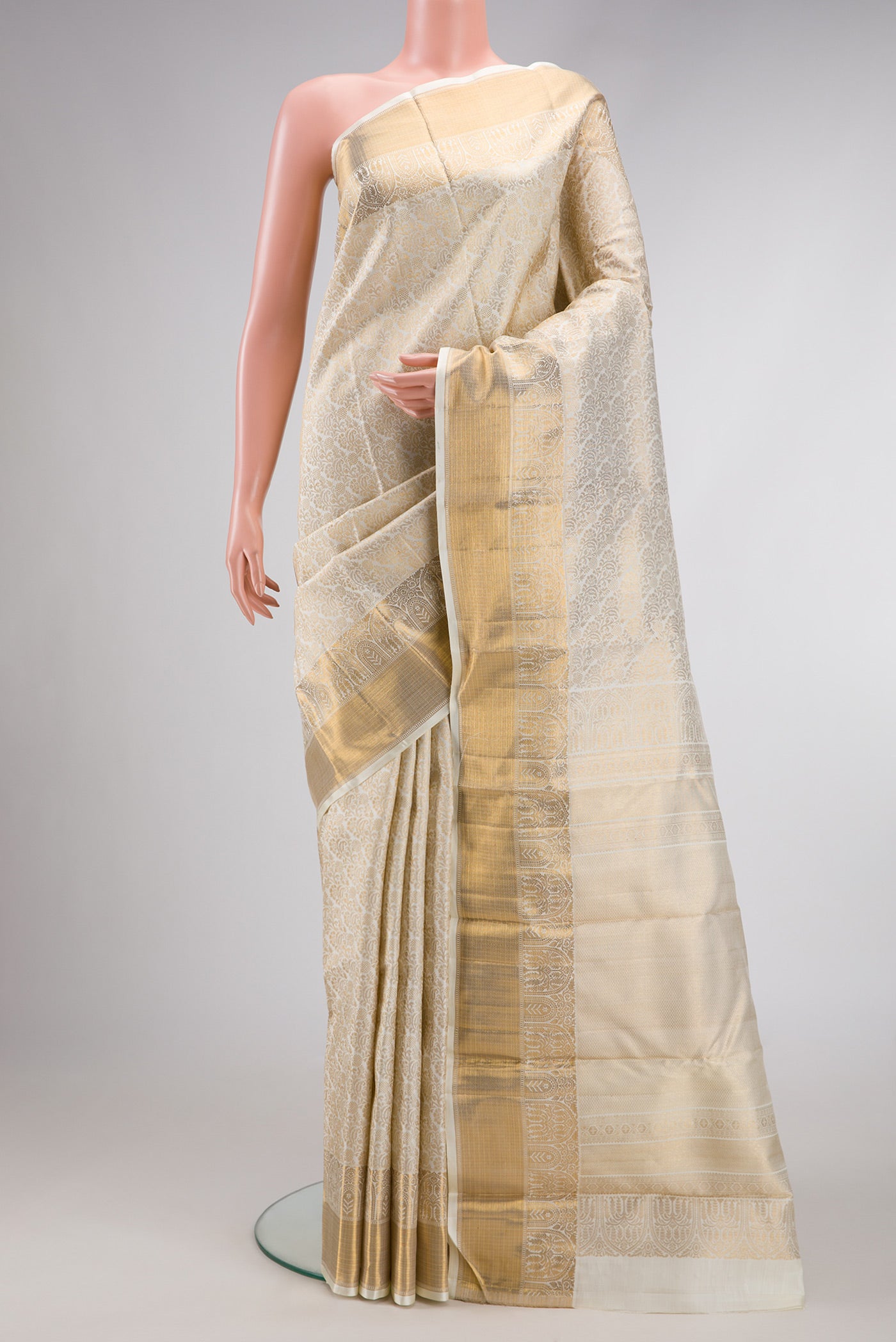 Off White Dual Tone Kanchipuram Silk Saree with Zari Brocade on the body and Zari Border.  displayed on a mannequin