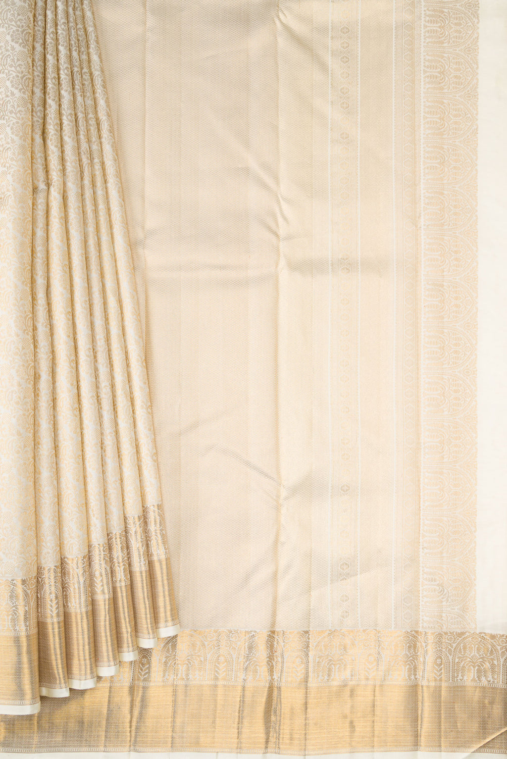 Pleats and pallu of Off White Dual Tone Kanchipuram Silk Saree with Zari Brocade on the body and Zari Border. 