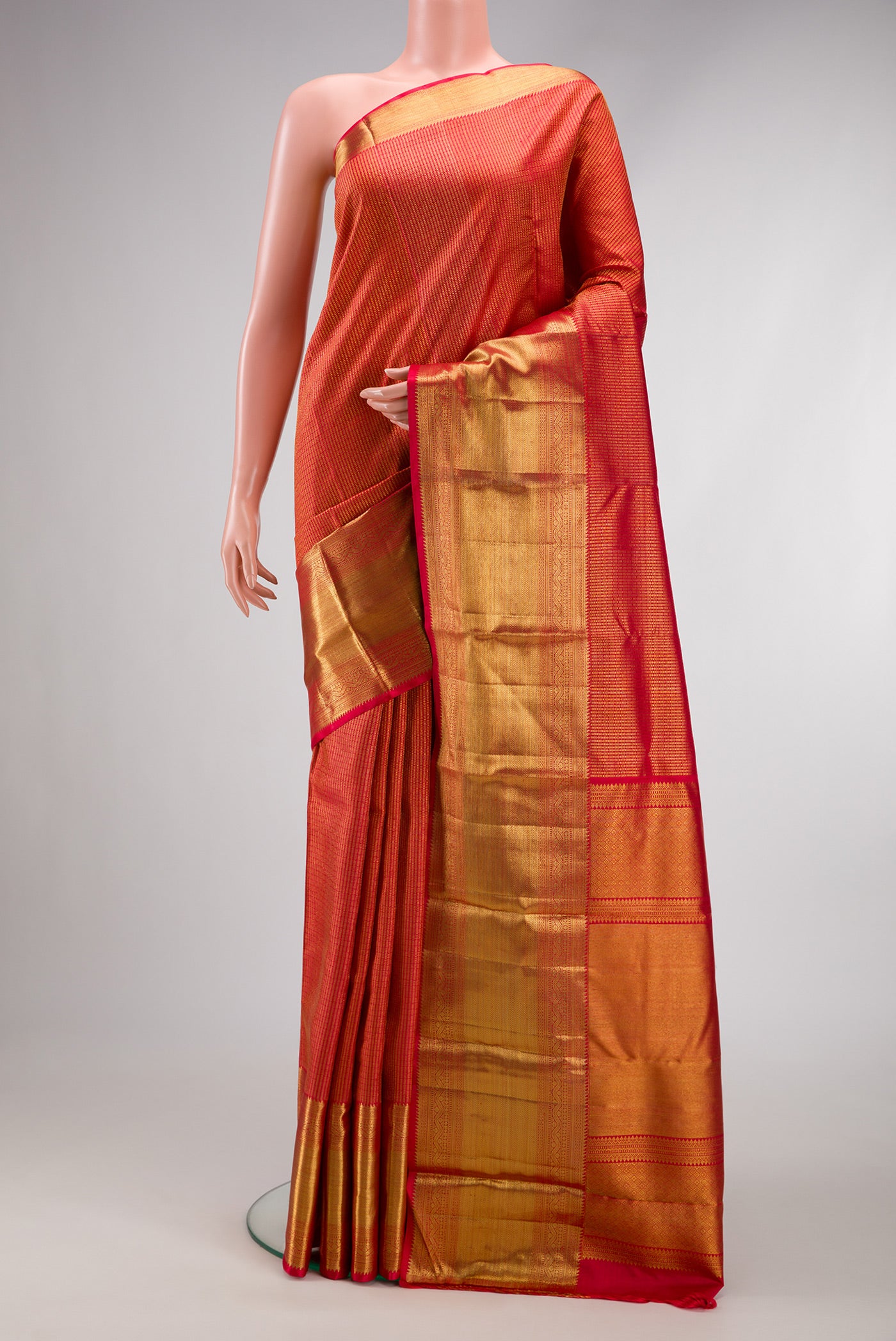Red Dual Tone Kanchipuram Silk Saree with Zari Brocade on the body and Zari Border.  displayed on a mannequin