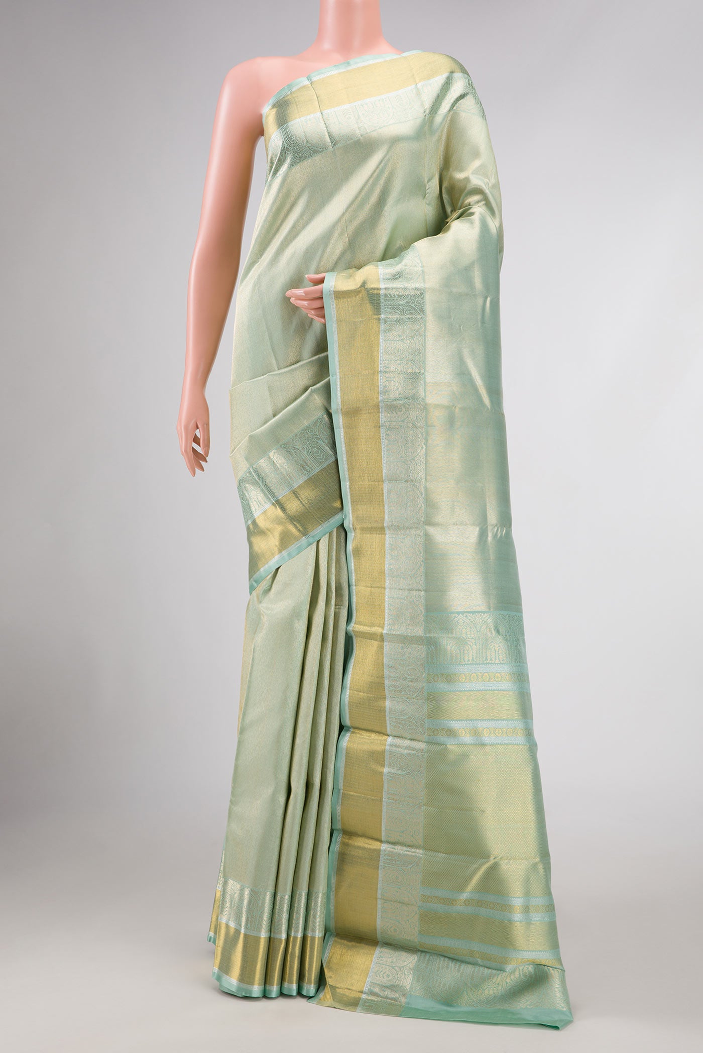 Light Green Dual Tone Kanchipuram Silk Saree with Zari Brocade on the body and Zari Border.  displayed on a mannequin