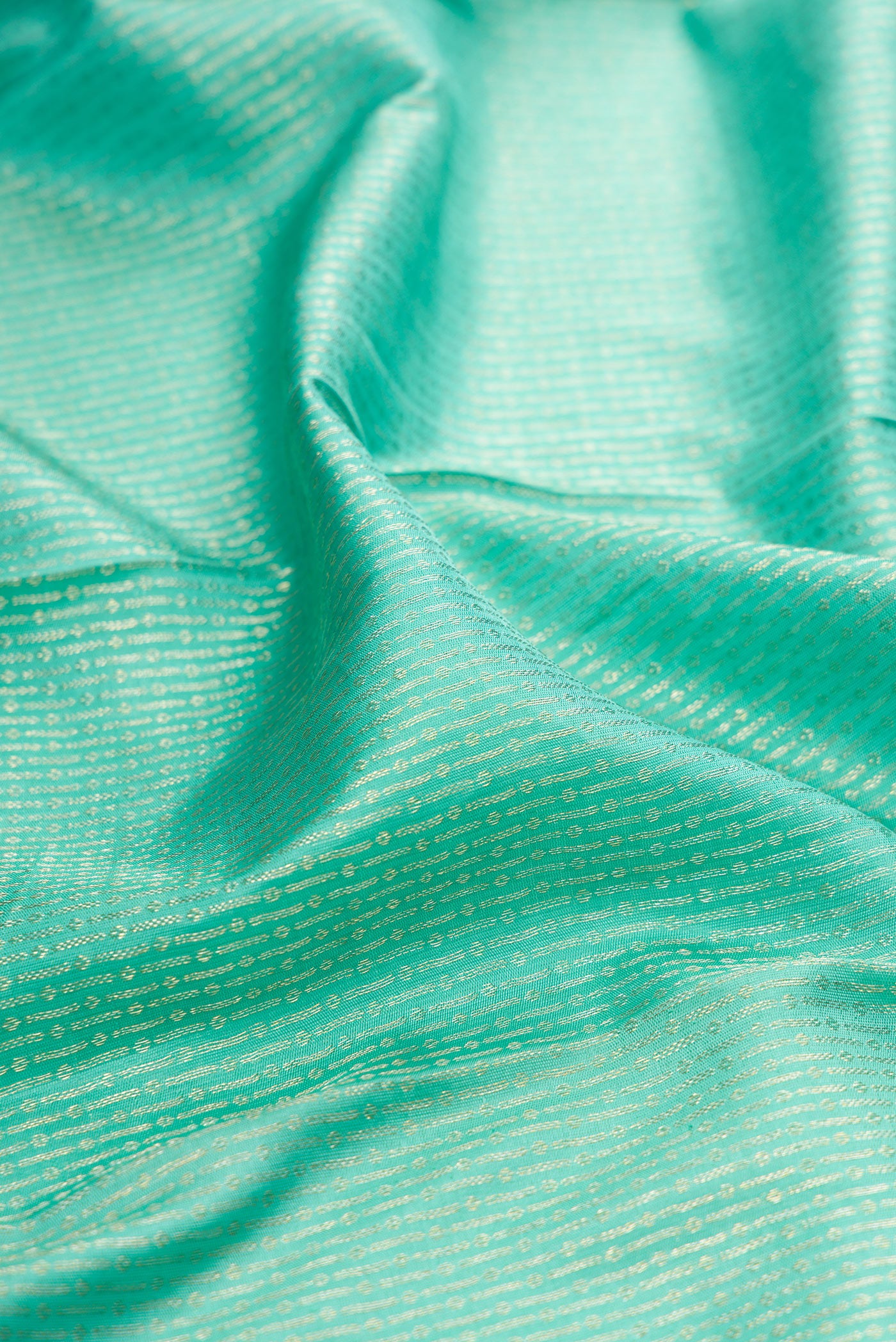 Close up of Sea Green Kanchipuram Silk Saree with Zari Brocade on the body and Zari Border.  displaying folds