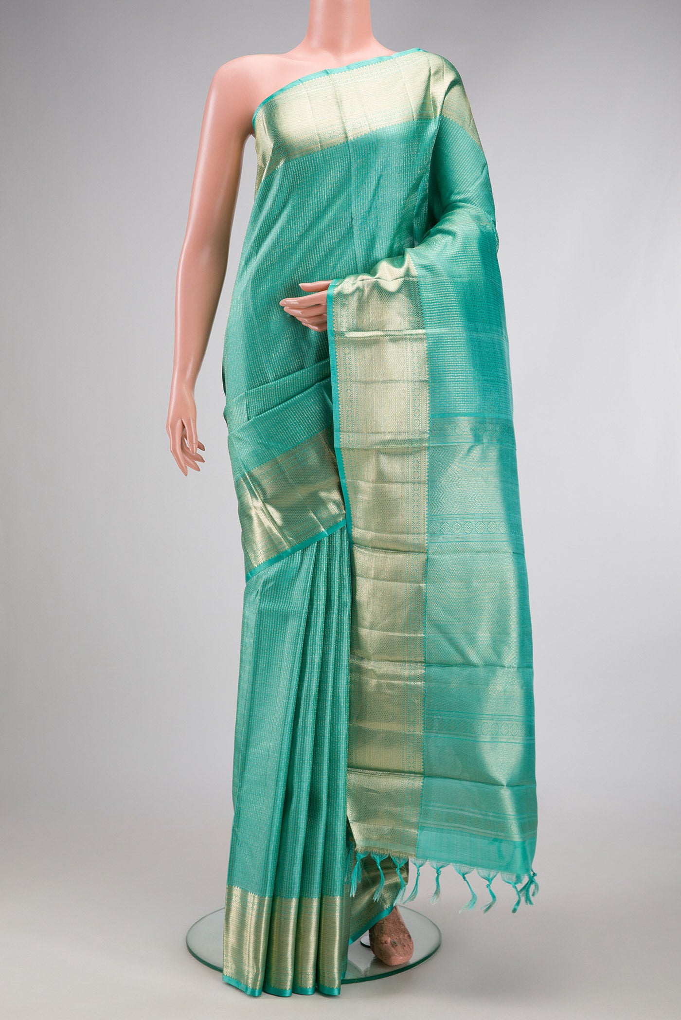 Sea Green Kanchipuram Silk Saree with Zari Brocade on the body and Zari Border.  displayed on a mannequin