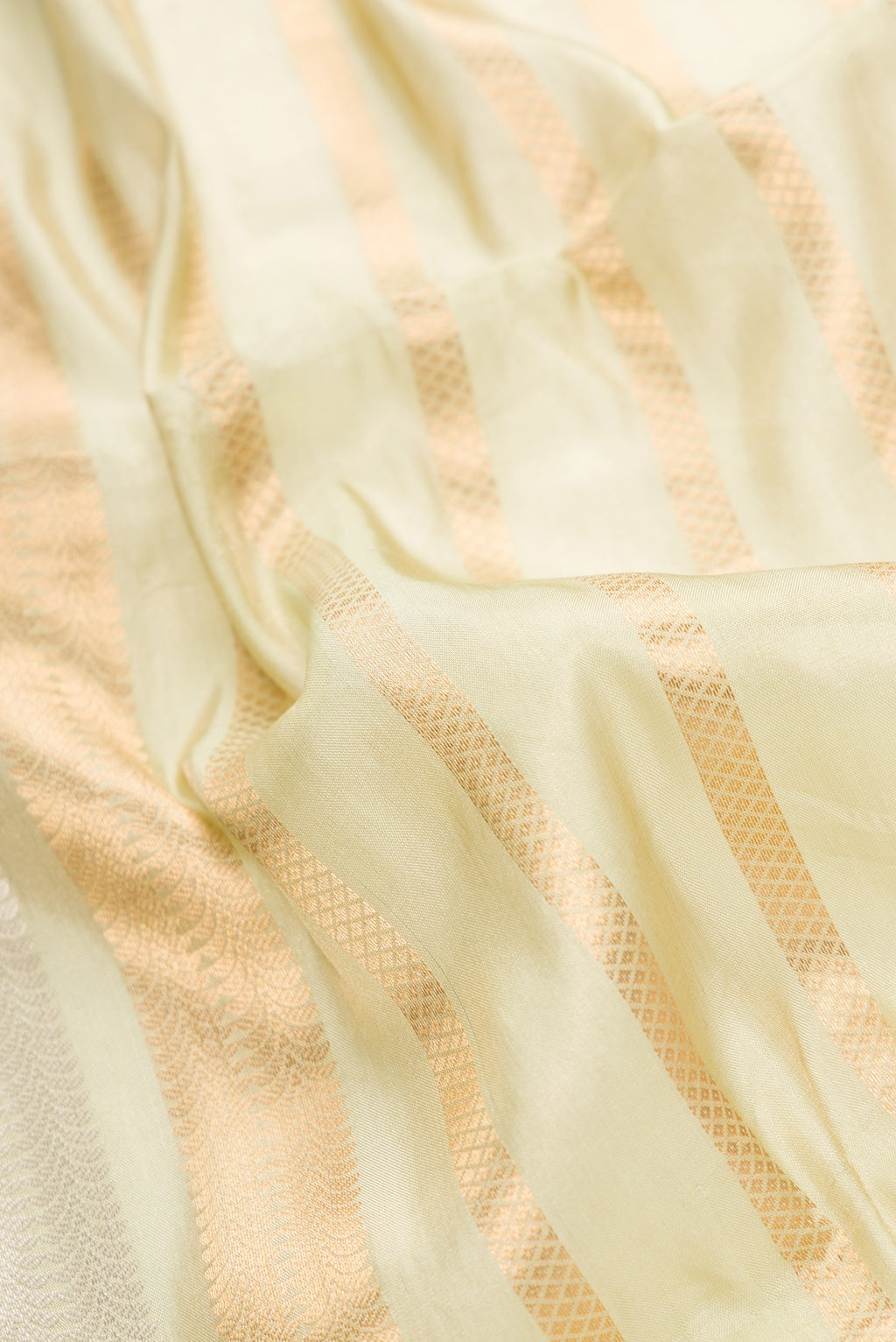 Close up of Pista Green Dual Tone Organza Silk Saree with Stripes on the body and Without Border.  displaying folds