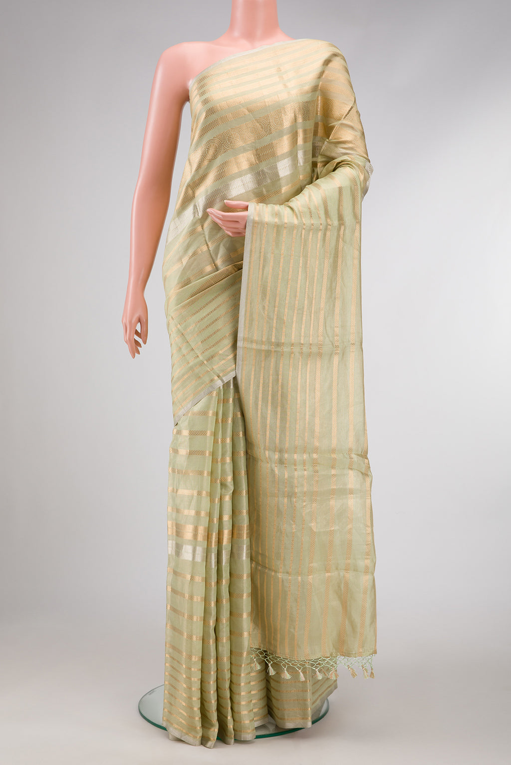 Pista Green Dual Tone Organza Silk Saree with Stripes on the body and Without Border.  displayed on a mannequin