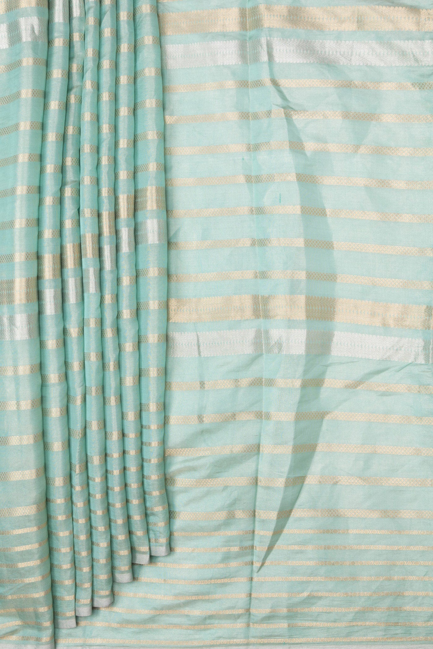 Pleats and pallu of Sea Green Dual Tone Organza Silk Saree with Stripes on the body and Zari Border. 