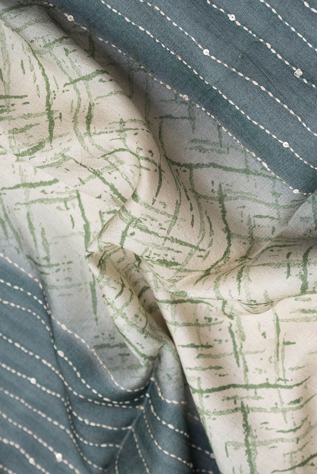 Close up of Grey Dual Tone Tussar Silk Saree with Embroidery on the body and Zari Border.  displaying folds