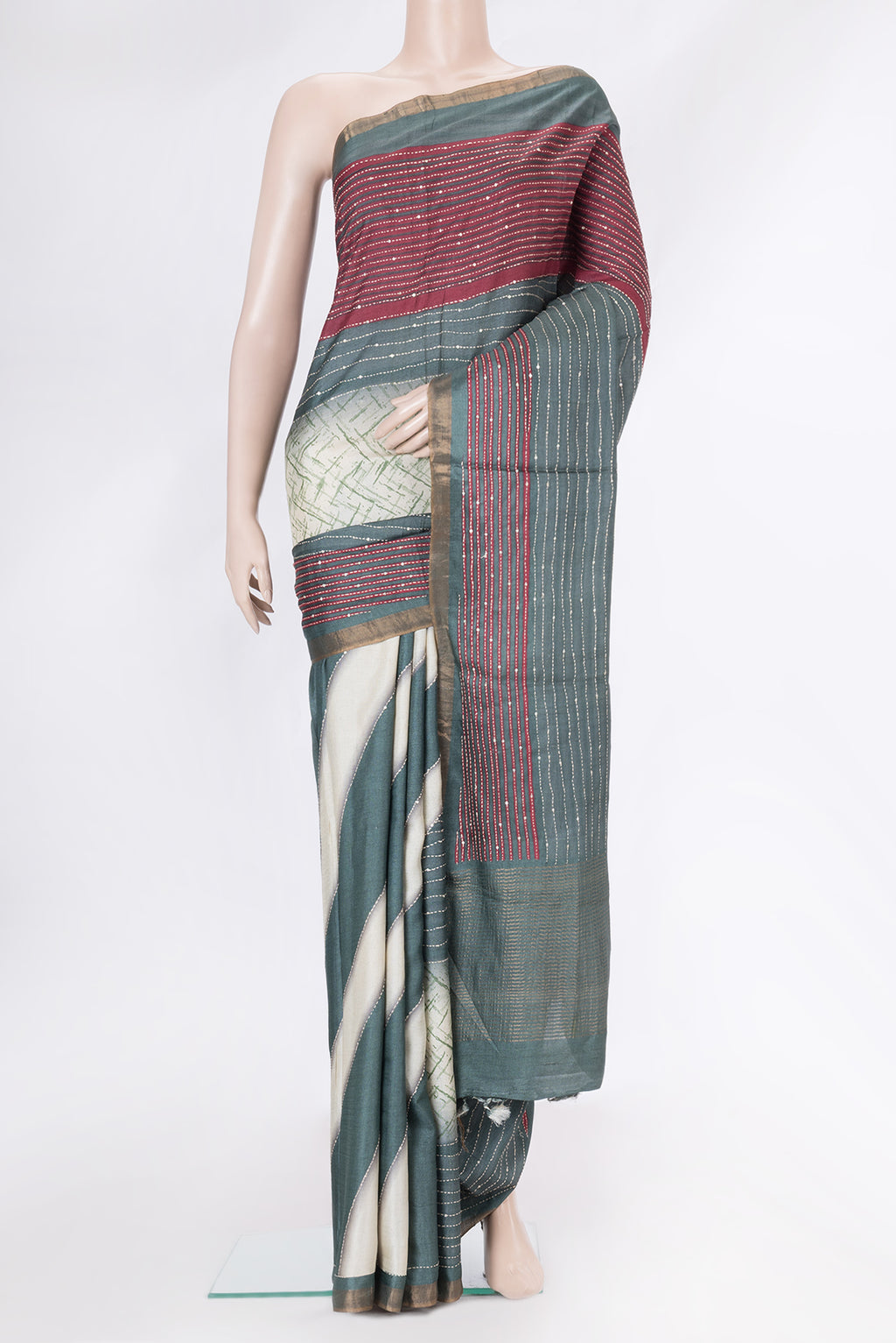 Grey Dual Tone Tussar Silk Saree with Embroidery on the body and Zari Border.  displayed on a mannequin