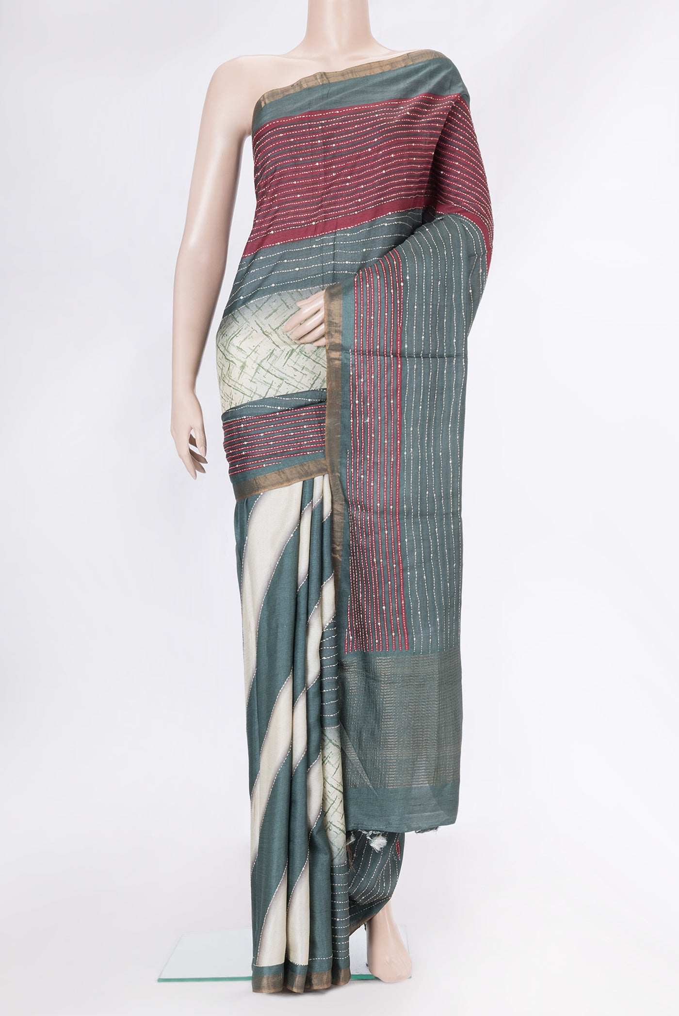 Grey Dual Tone Tussar Silk Saree with Embroidery on the body and Zari Border.  displayed on a mannequin