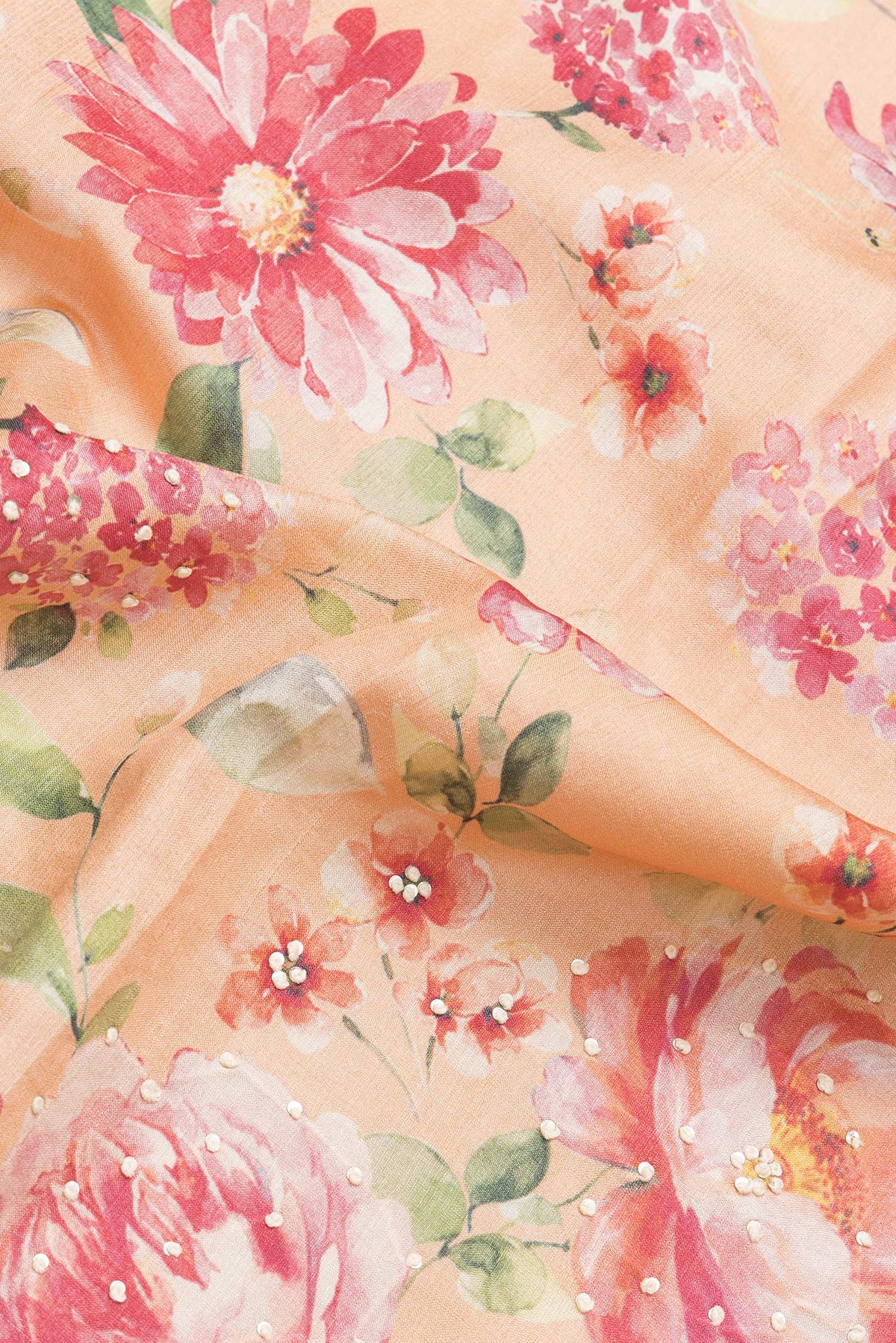 Close up of Peach Dual Tone Tussar Silk Saree with Embroidery on the body and Zari Border.  displaying folds