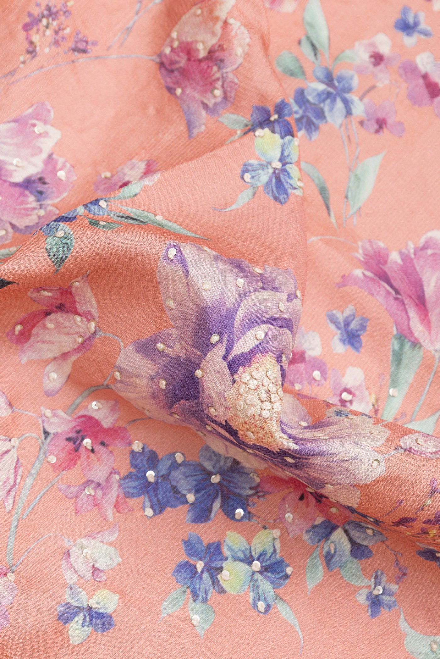Close up of Peach Dual Tone Tussar Silk Saree with Embroidery on the body and Zari Border.  displaying folds