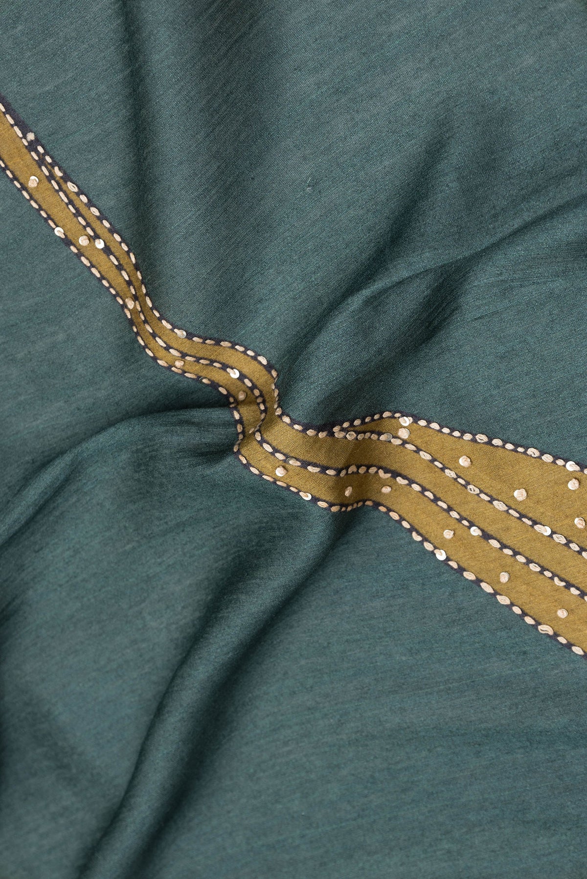 Close up of Mehandi Green Dual Tone Tussar Silk Saree with Embroidery on the body and Zari Border.  displaying folds